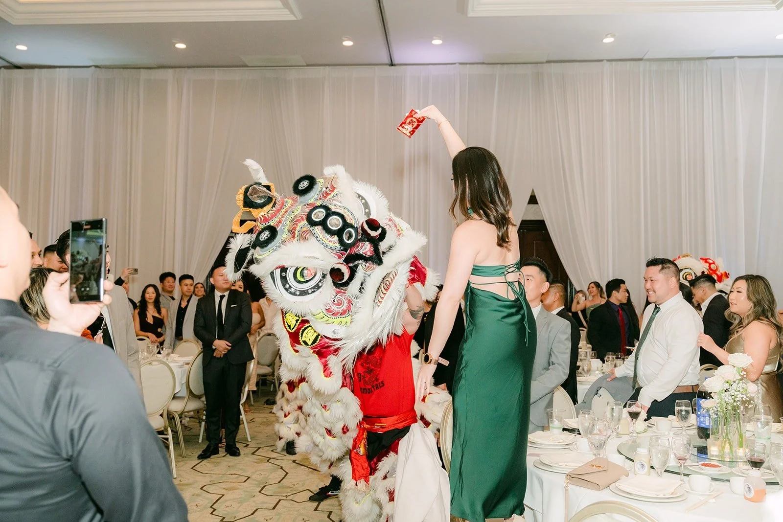 Guests filming as the lions dance through the ballroom