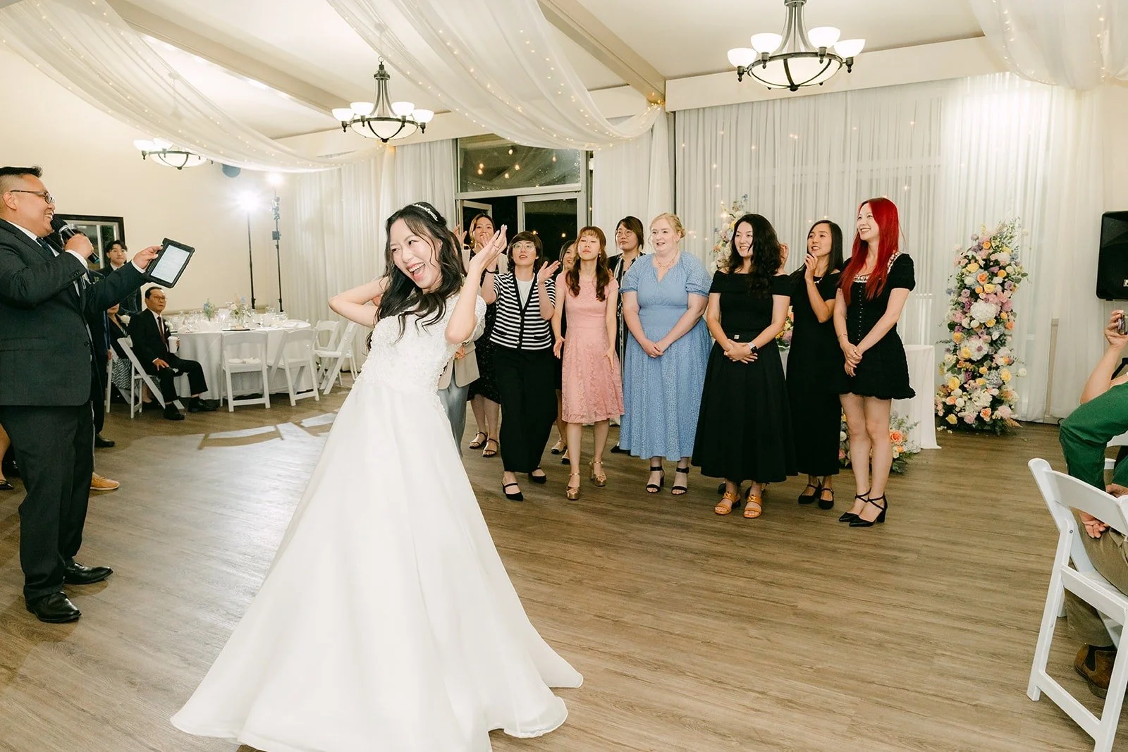 Jeannie getting ready to toss her bouquet as guests gather