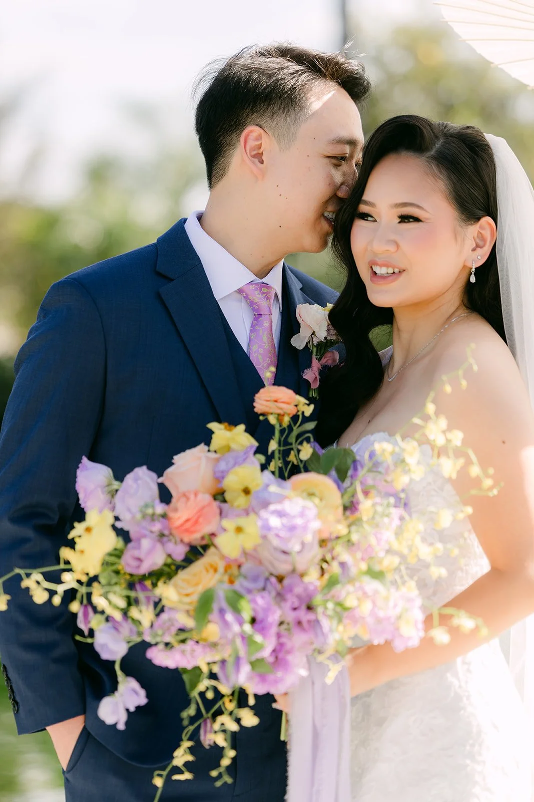 Elijah kissing Vannie's temple as she smiles.