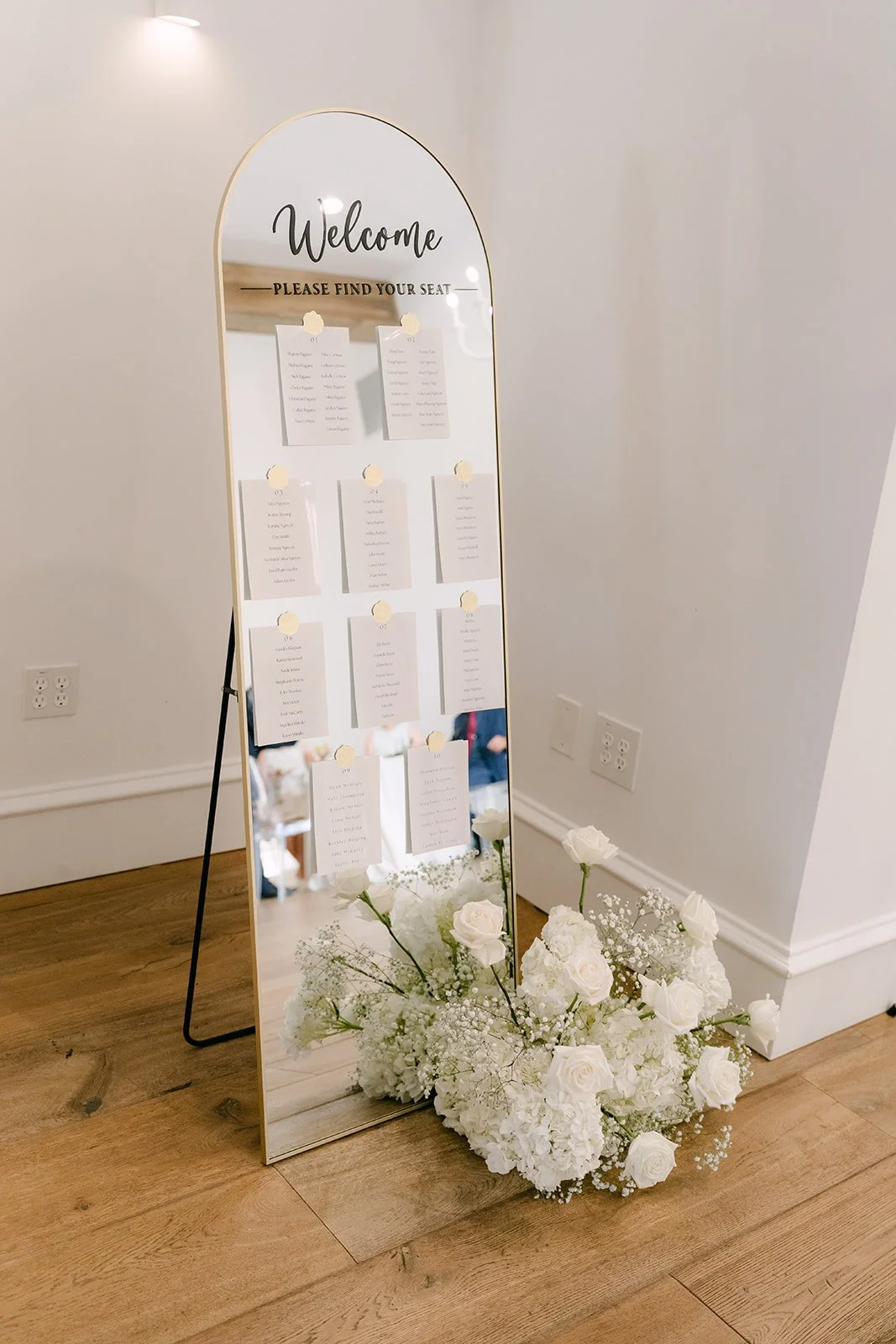 Welcome seating chart sign with white florals