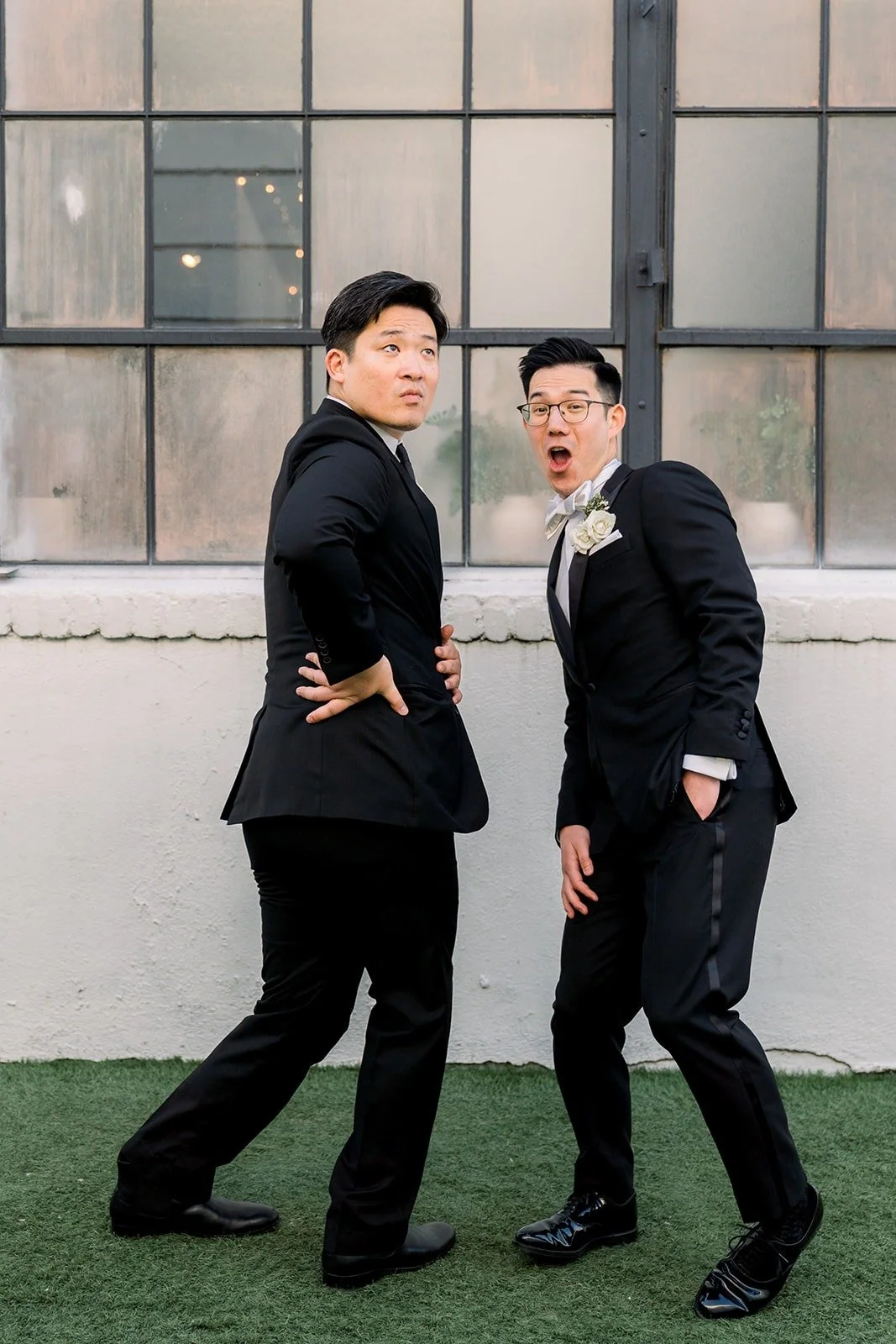 Alex and a groomsman strike a playful pose