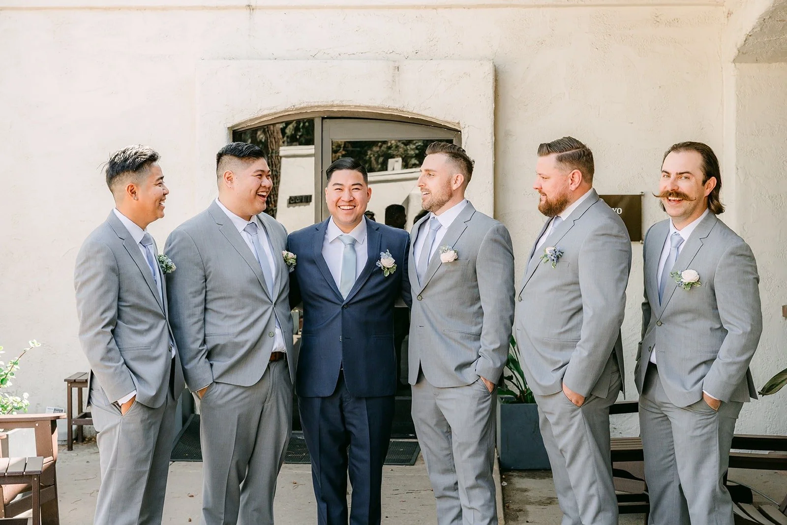 Jordan and his groomsmen in gray suits lined up at Brookside