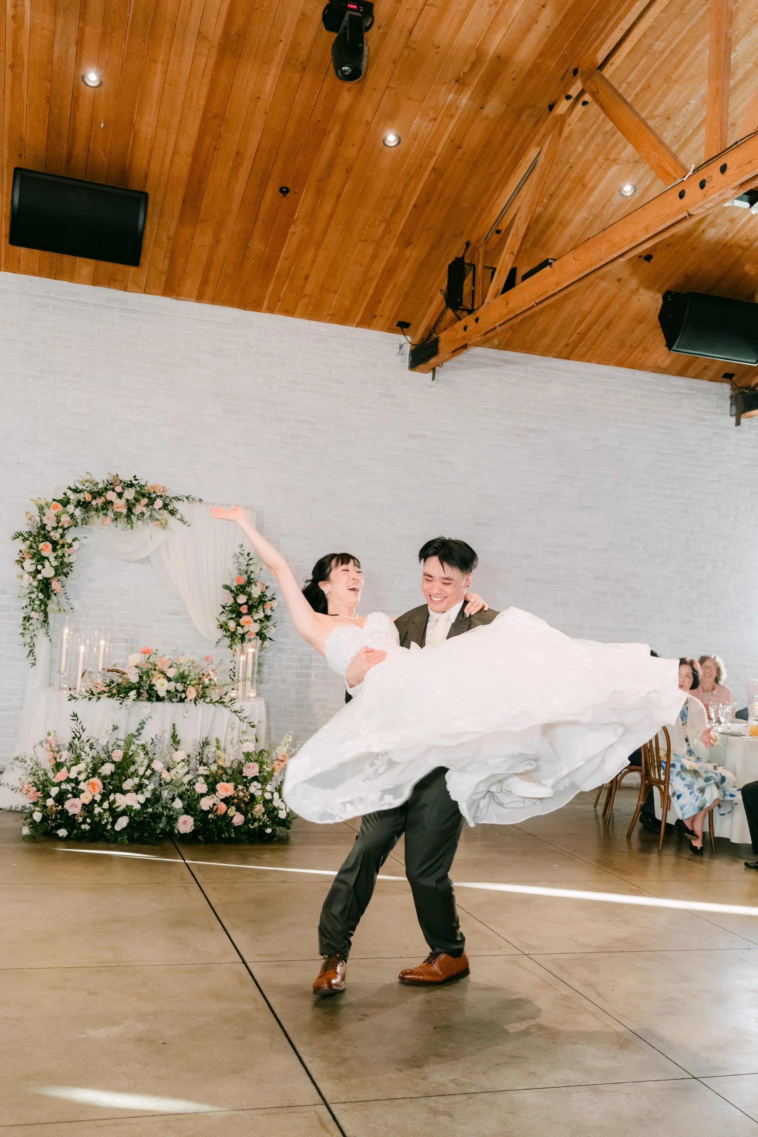 Alex lifting Vivian during their first dance at The Colony House in Anaheim