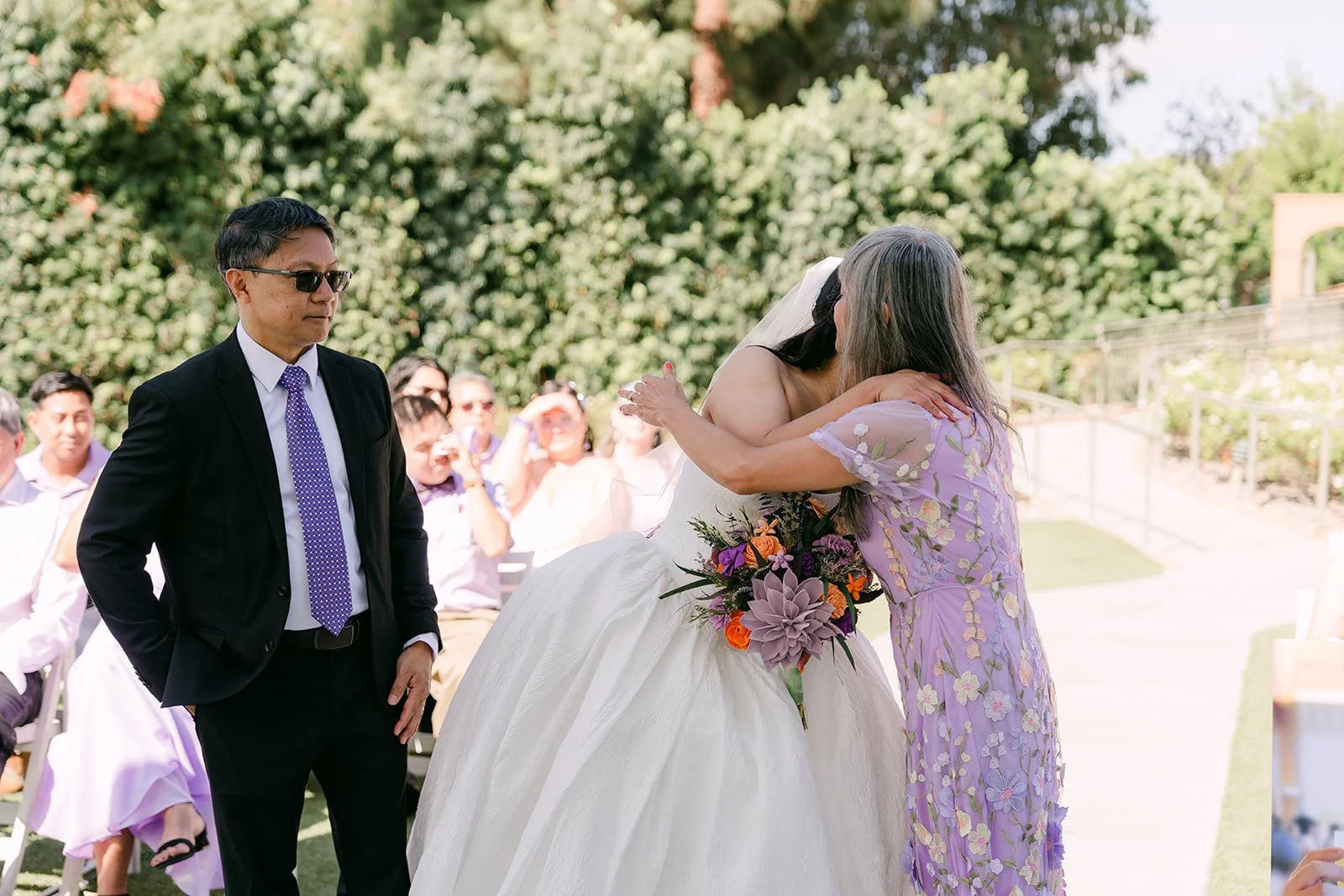 Angela hugging her mom at the end of the aisle