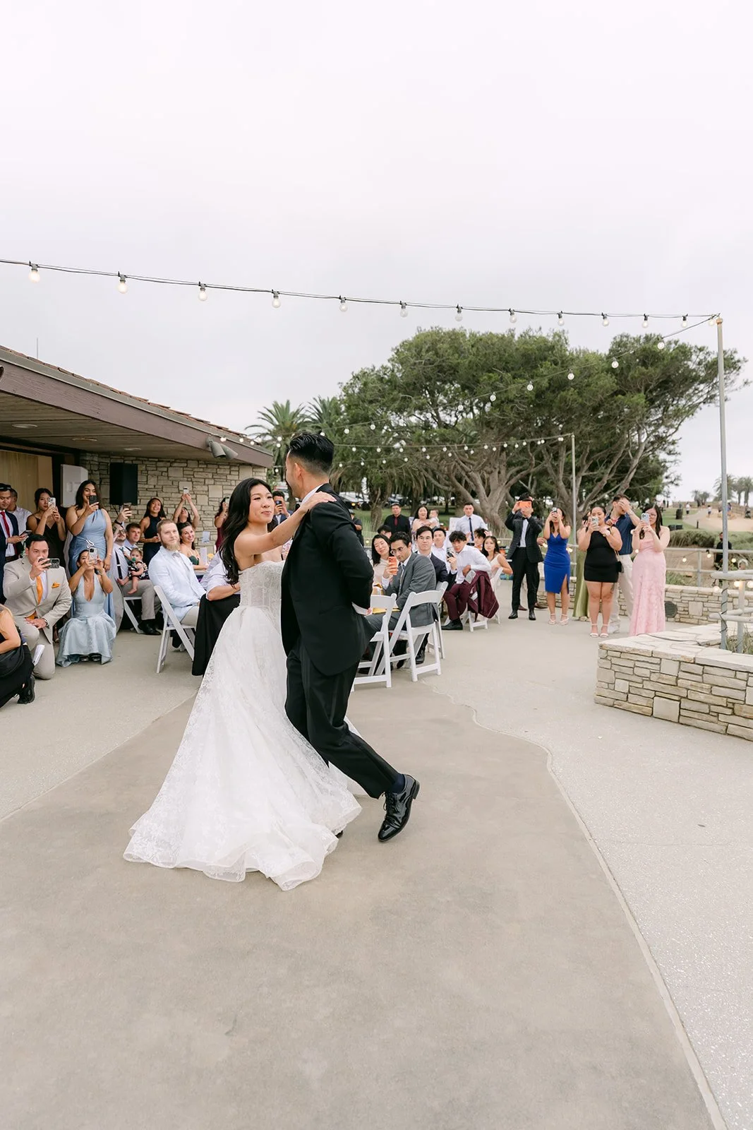 First dance on the patio with the ocean behind them