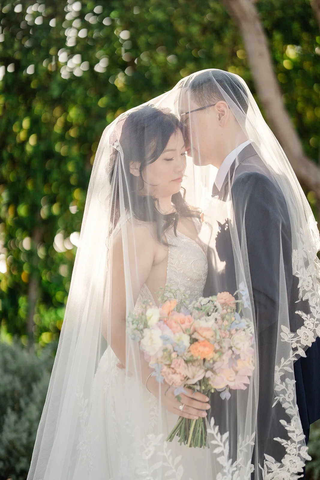 Forehead kiss under the bride's veil