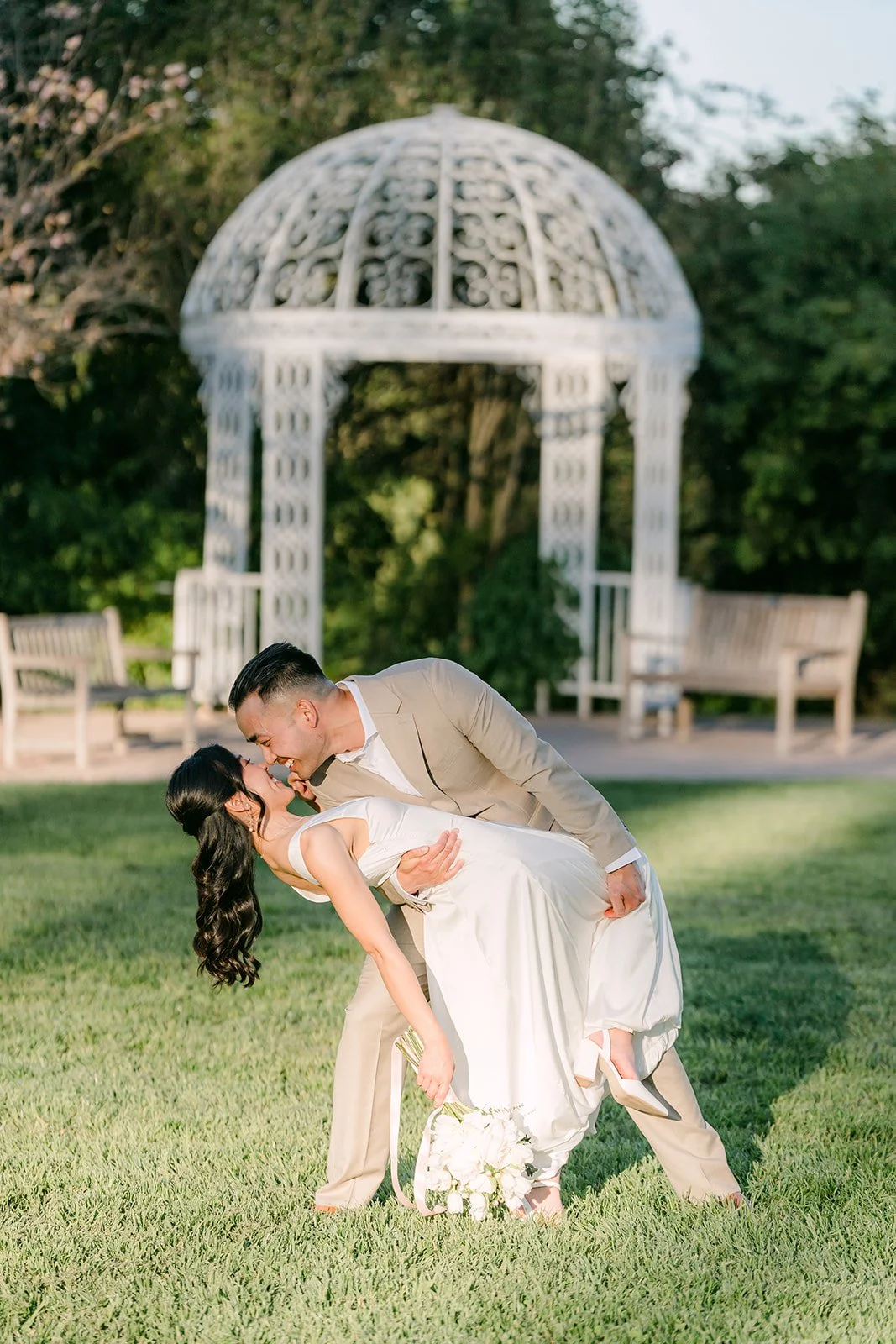 Vincent dips Kim for a kiss in front of the gazebo.