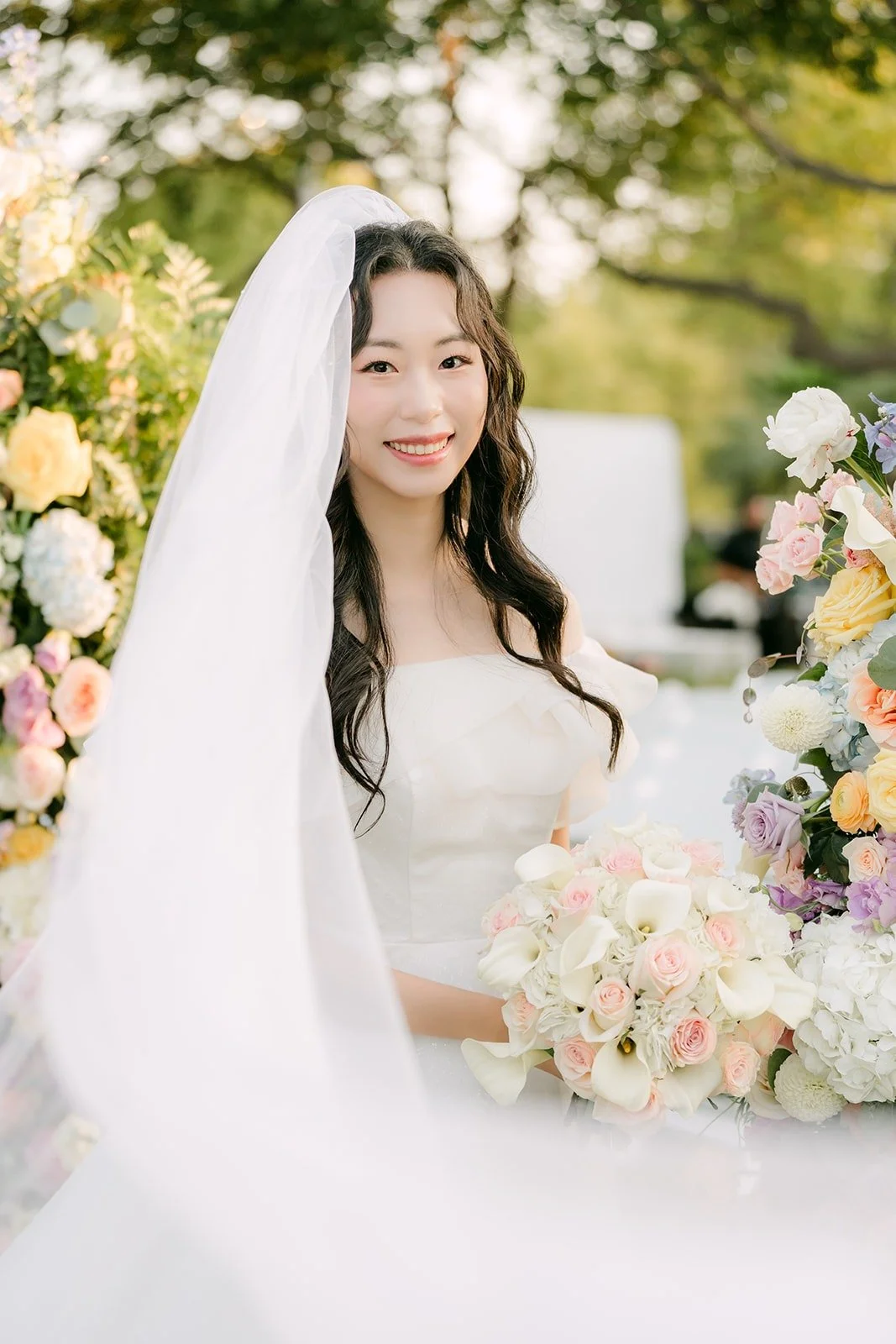 Jeannie's soft smile under her veil, photographed by One and Only Production