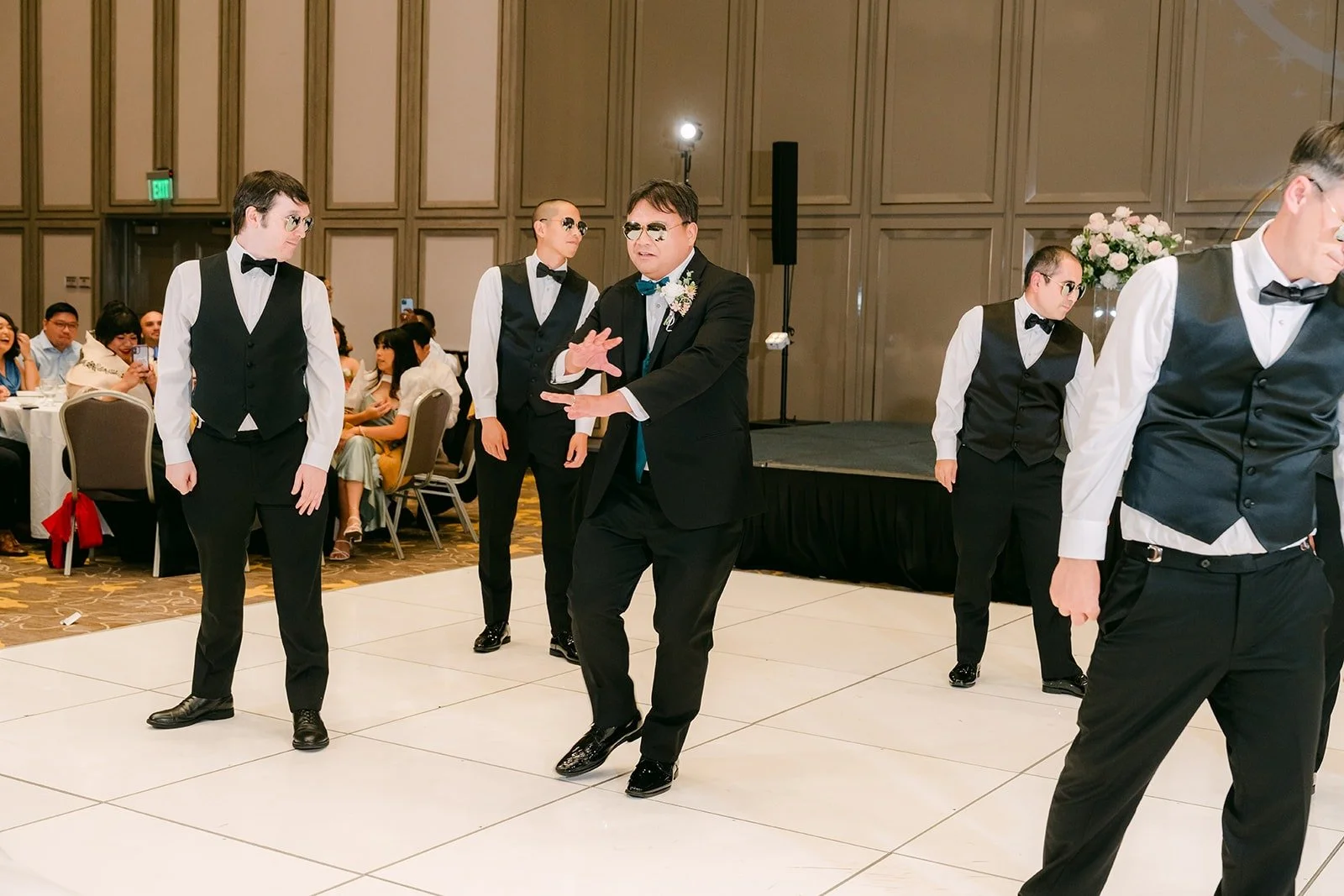 The groomsmen striking a final pose at the end of the surprise dance