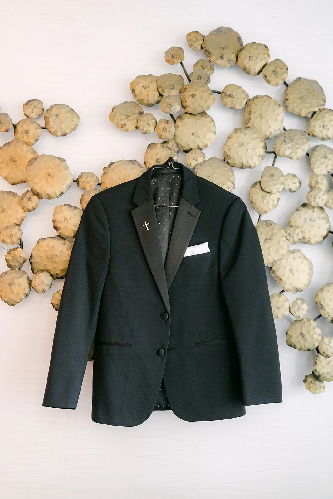 Daniel's black tuxedo jacket hanging on the Groom Suite wall