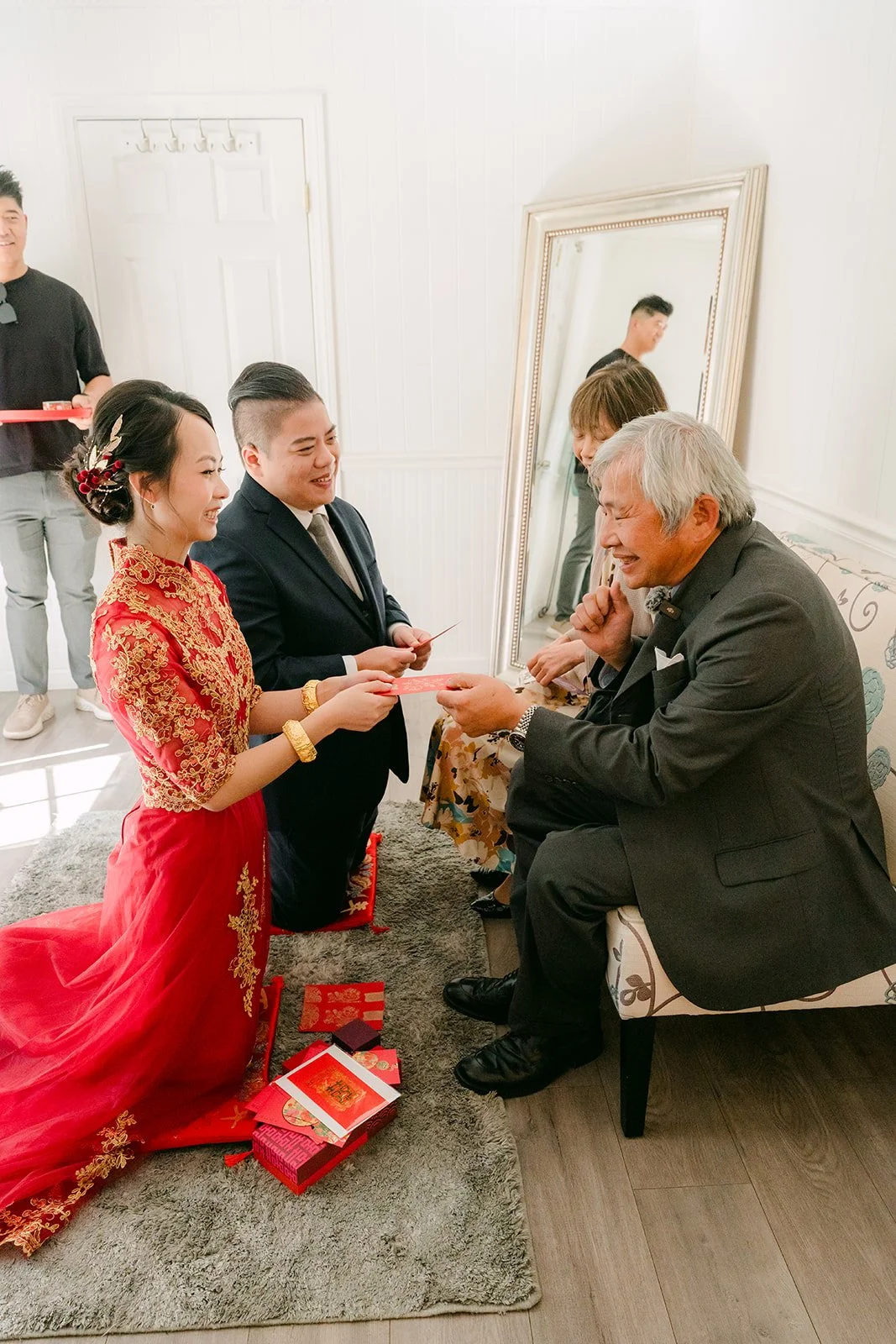 An elder sipping tea from the bride and groom during the tea ceremony.