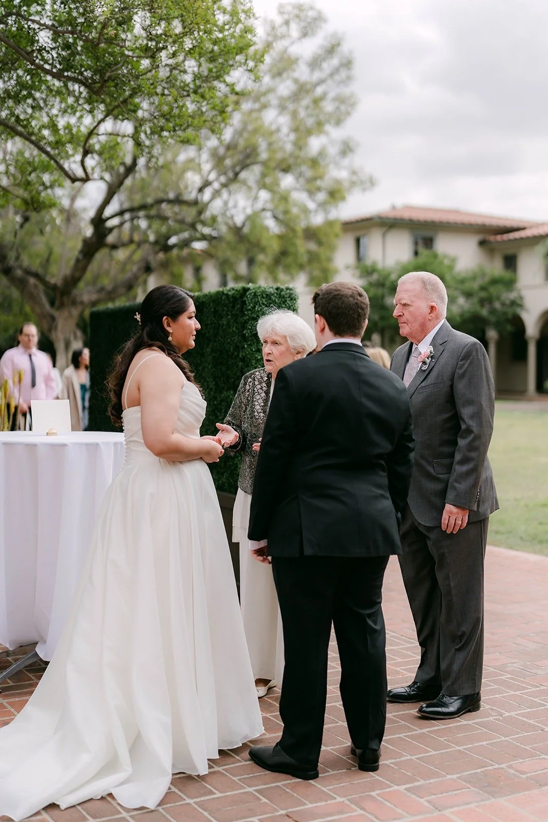 Saira and Matthew greeting a guest during the welcome hour