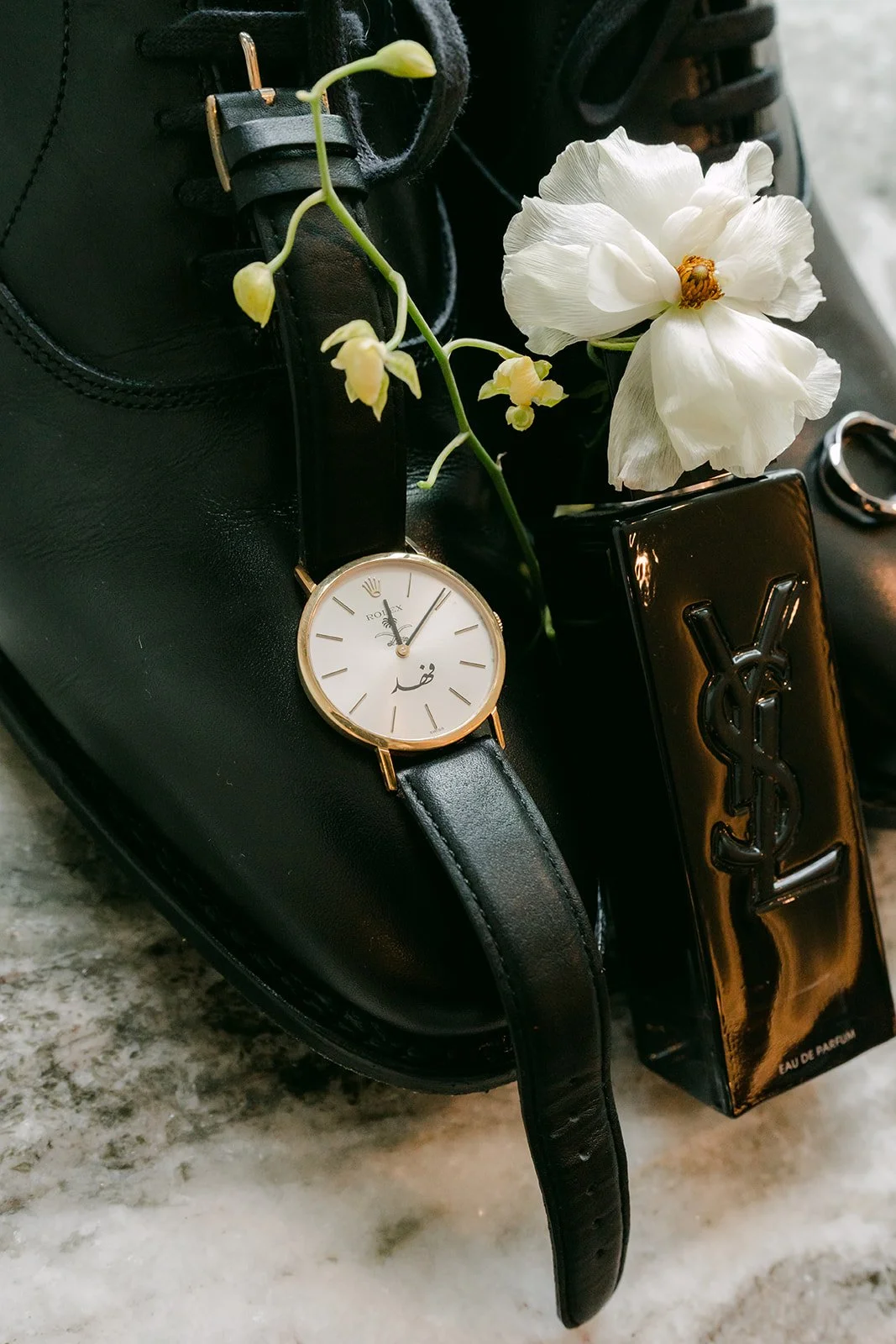 Ryan's watch and leather strap styled on black leather.