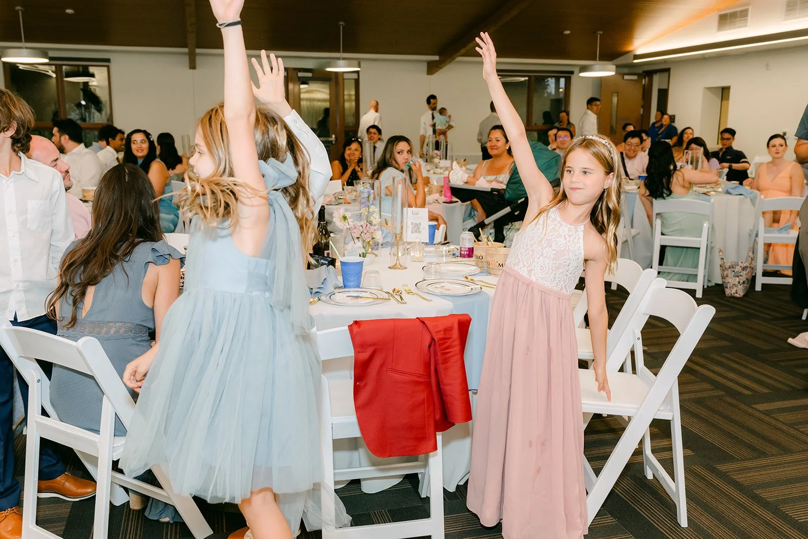 Guests raising their hands to answer during the reception games.