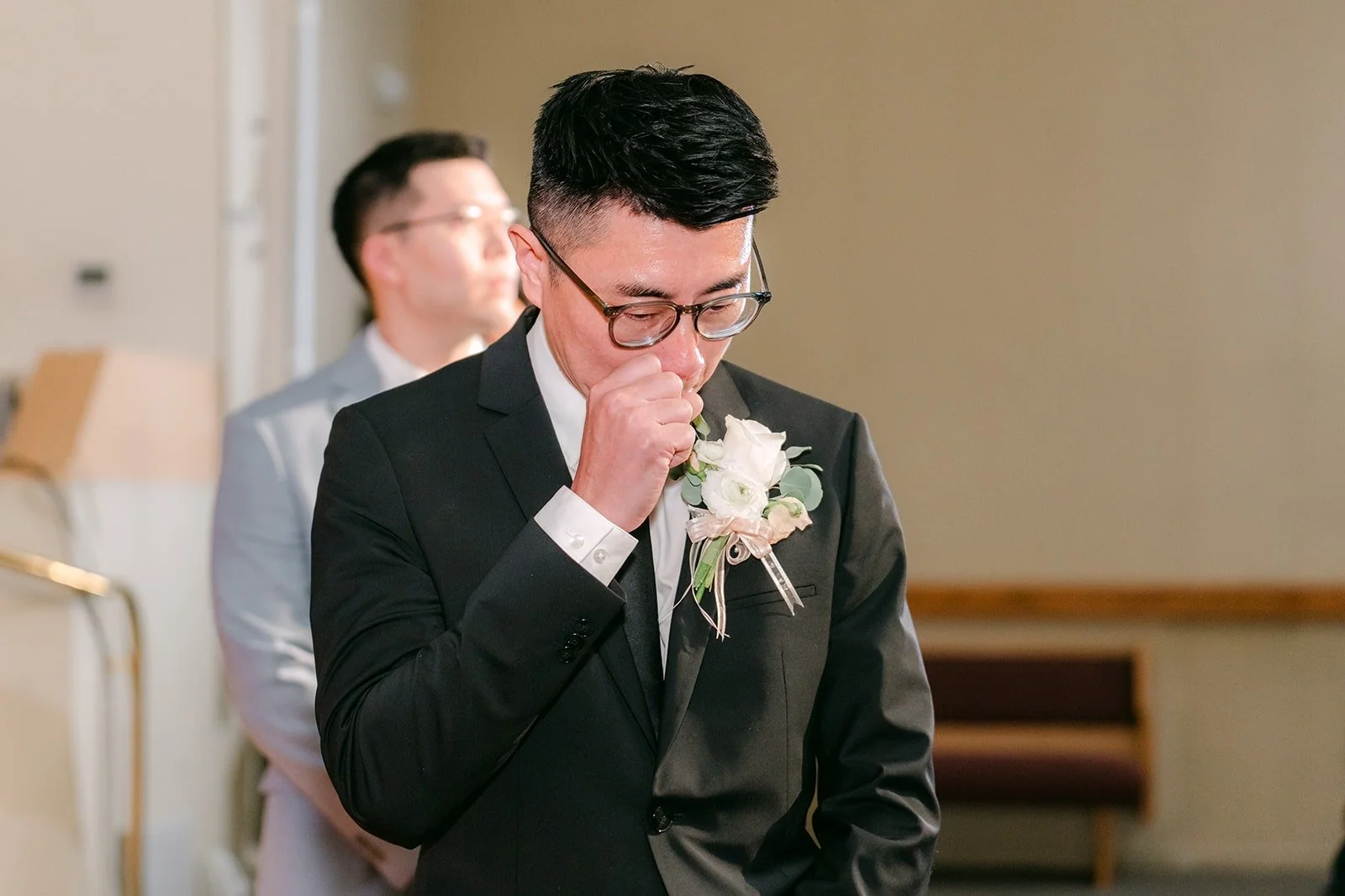 Eric wipes a tear as he waits at the front of the sanctuary