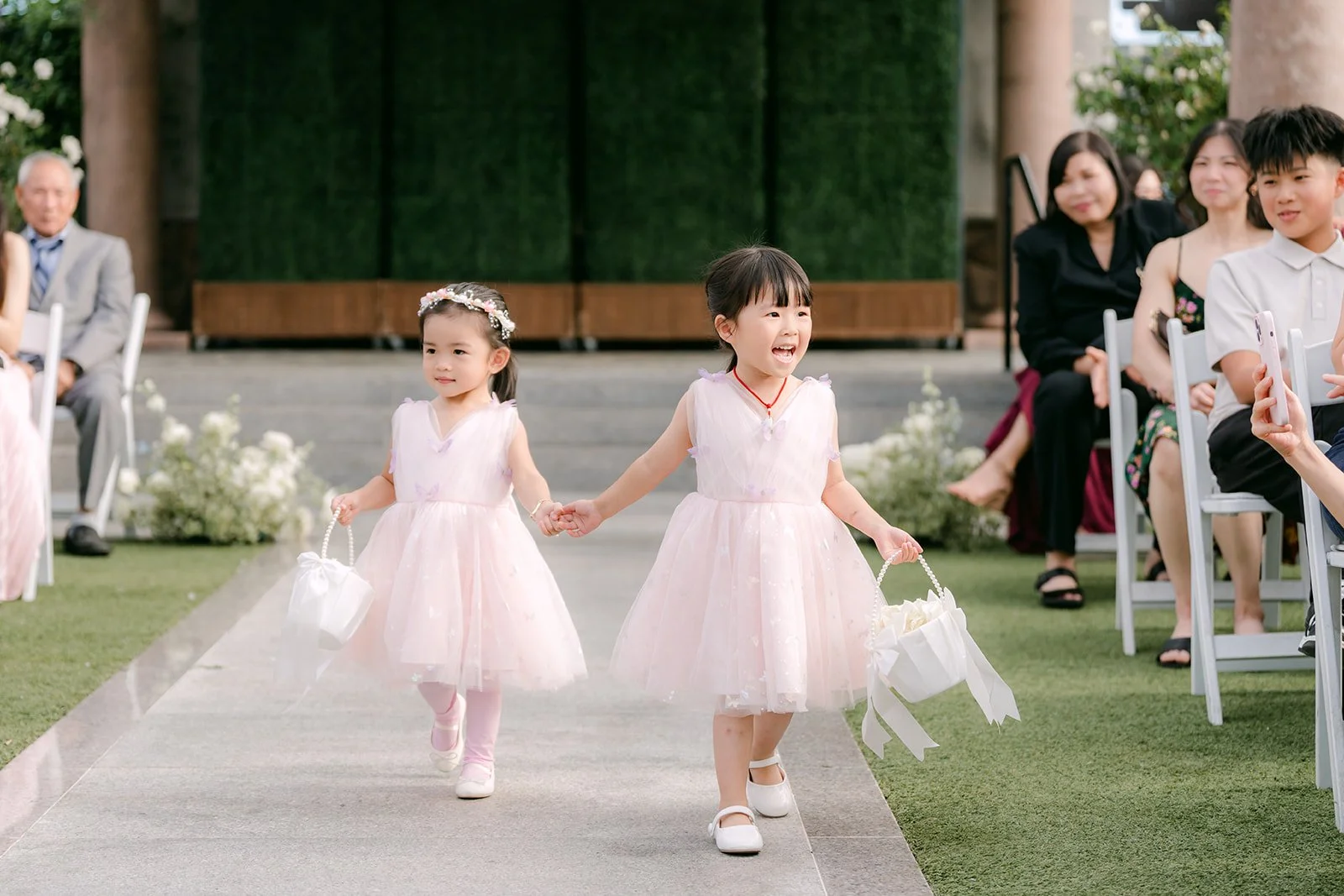 Flower girls skipping down the aisle