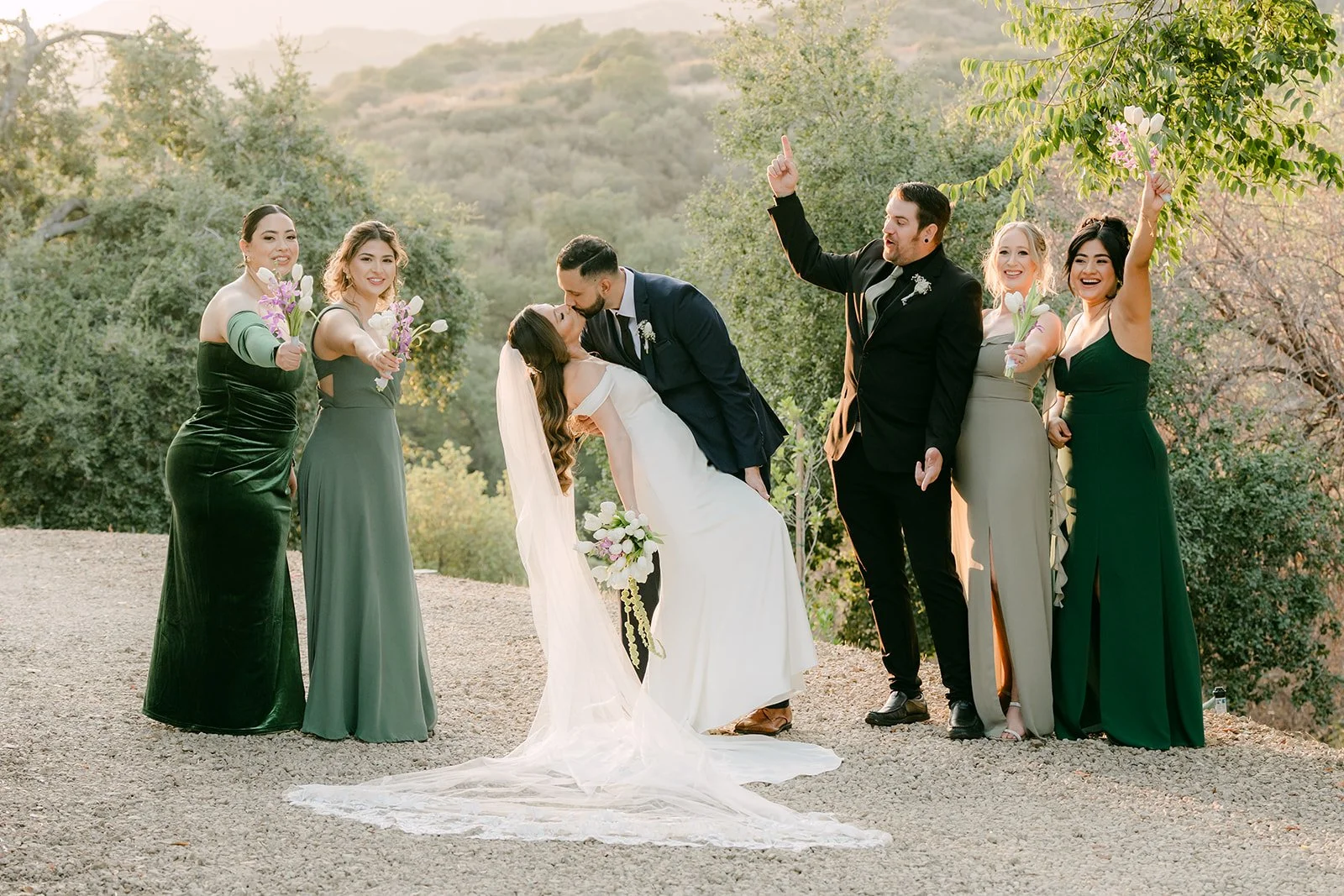Danny dipping Mariana as the wedding party cheers