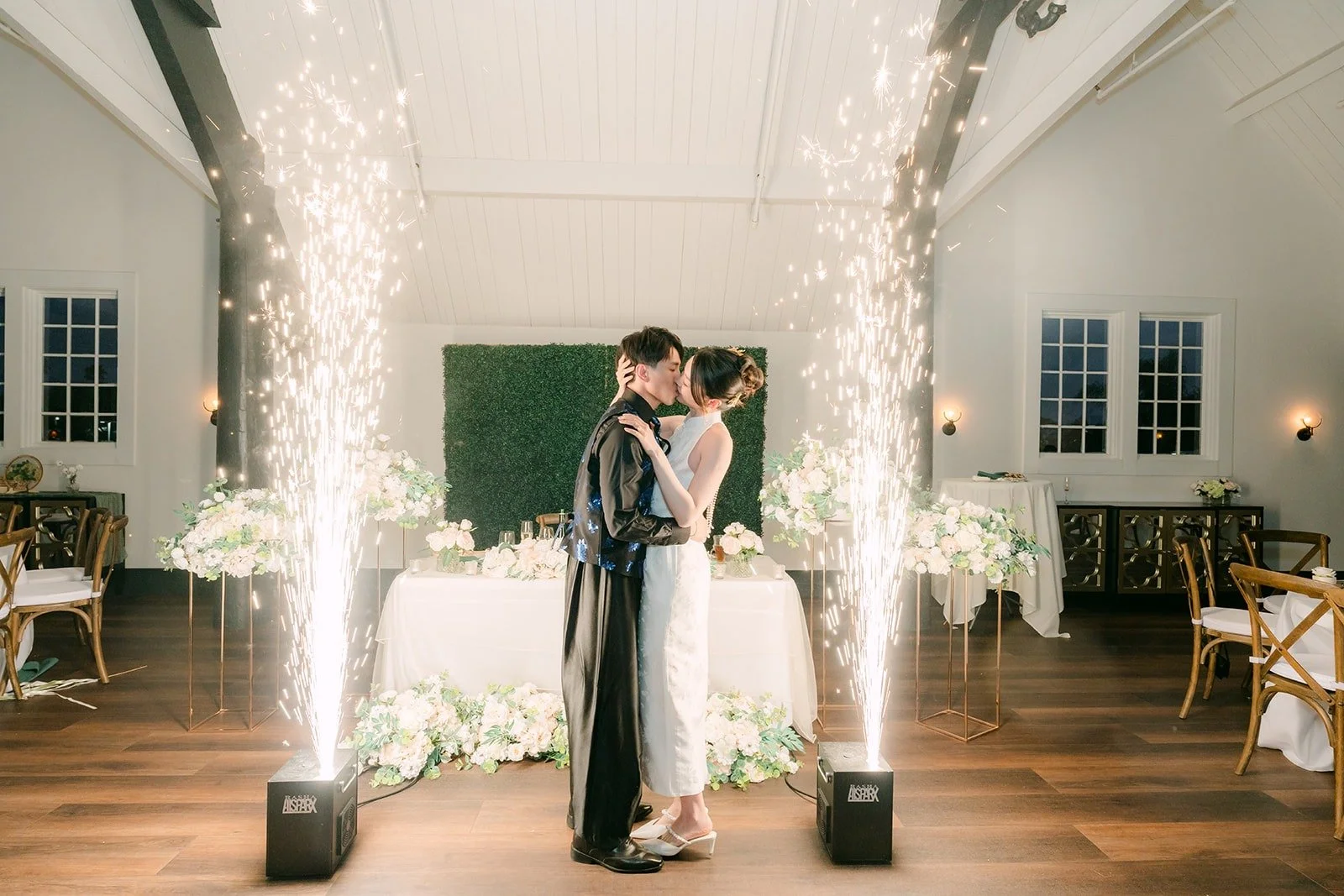 Tin and Fong embracing between sparkler fountains