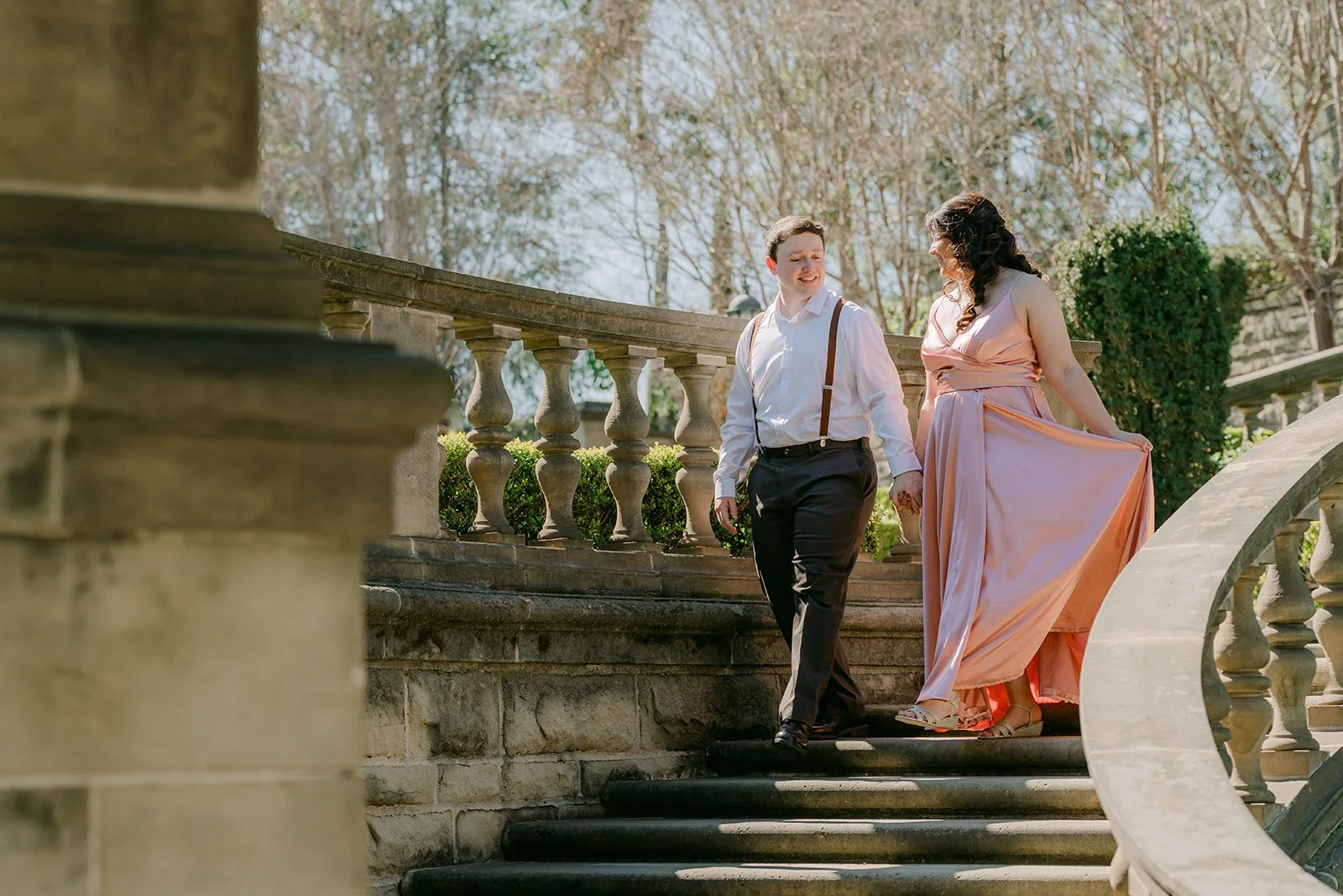 Saira and Matthew walking down the grand staircase at Greystone Mansion.