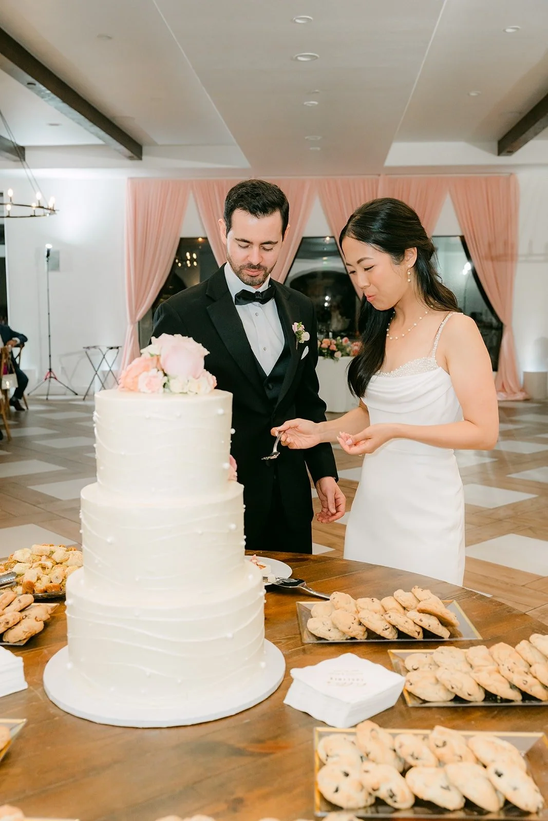 Stephanie and Kevin smiling after cutting the cake, photographed by One and Only Production