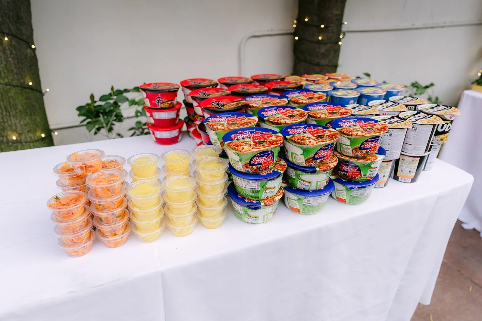 A late night snack table stacked with cup noodles