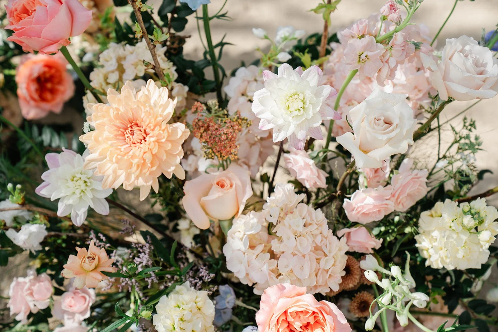 Close up of peach, pink and white ceremony florals