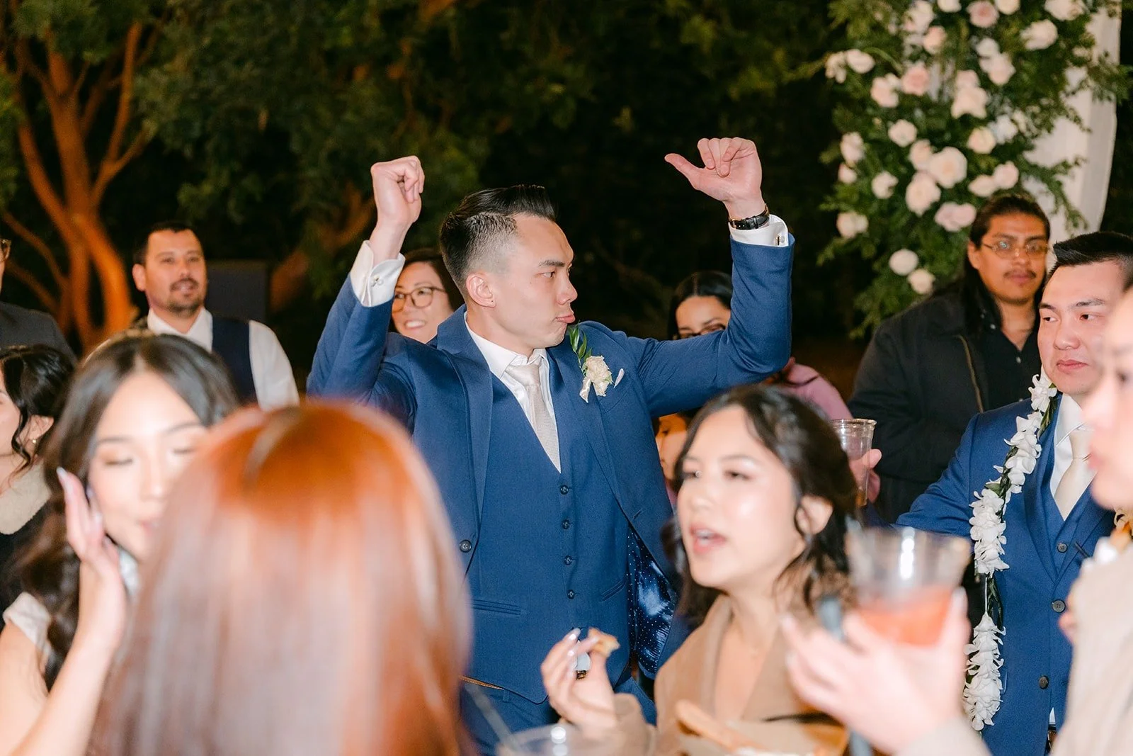 Alex and friends cheering with their arms in the air