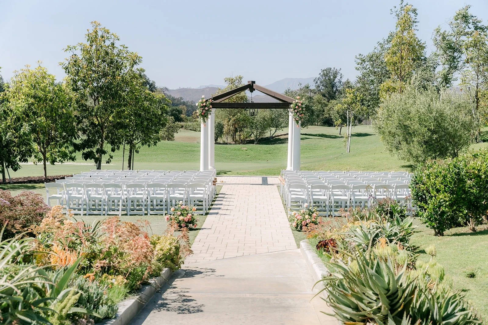 The ceremony aisle leading through the garden to the pagoda