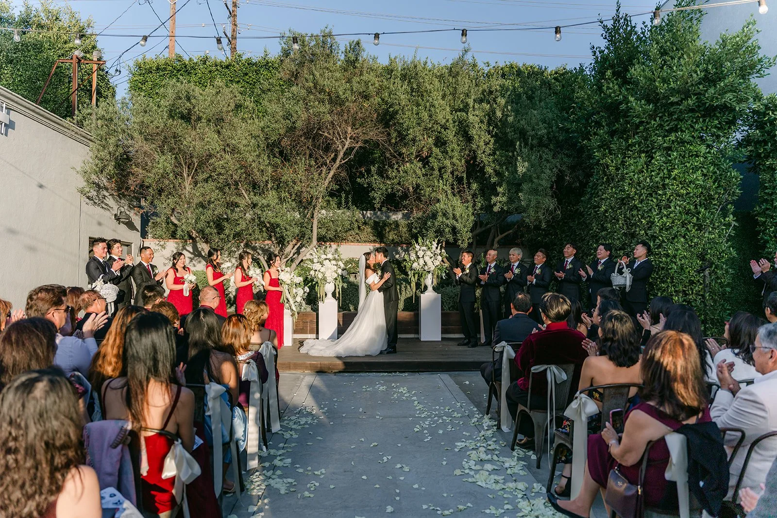 Wide view of the ceremony from the back under the string lights