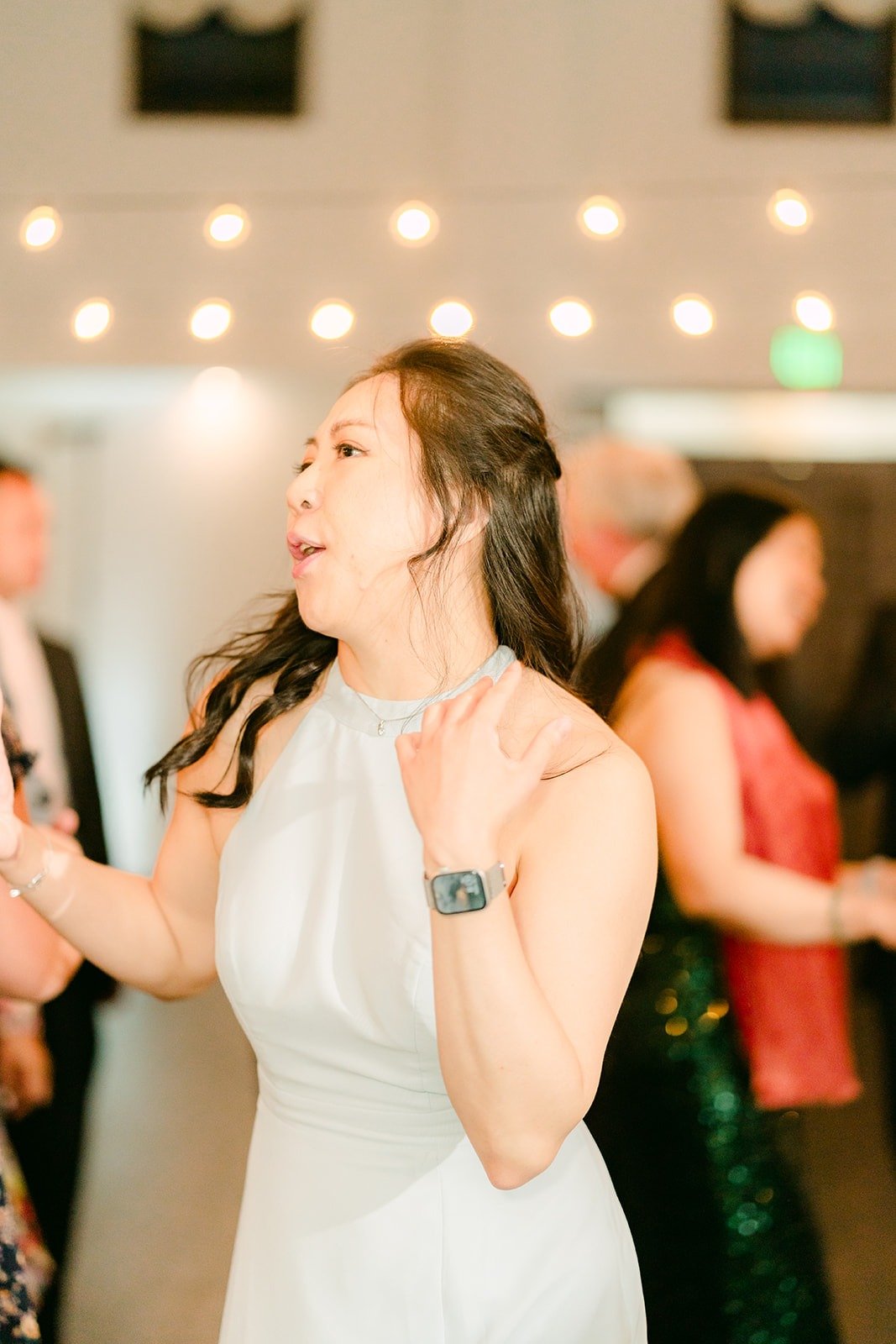 A guest singing along on the dance floor