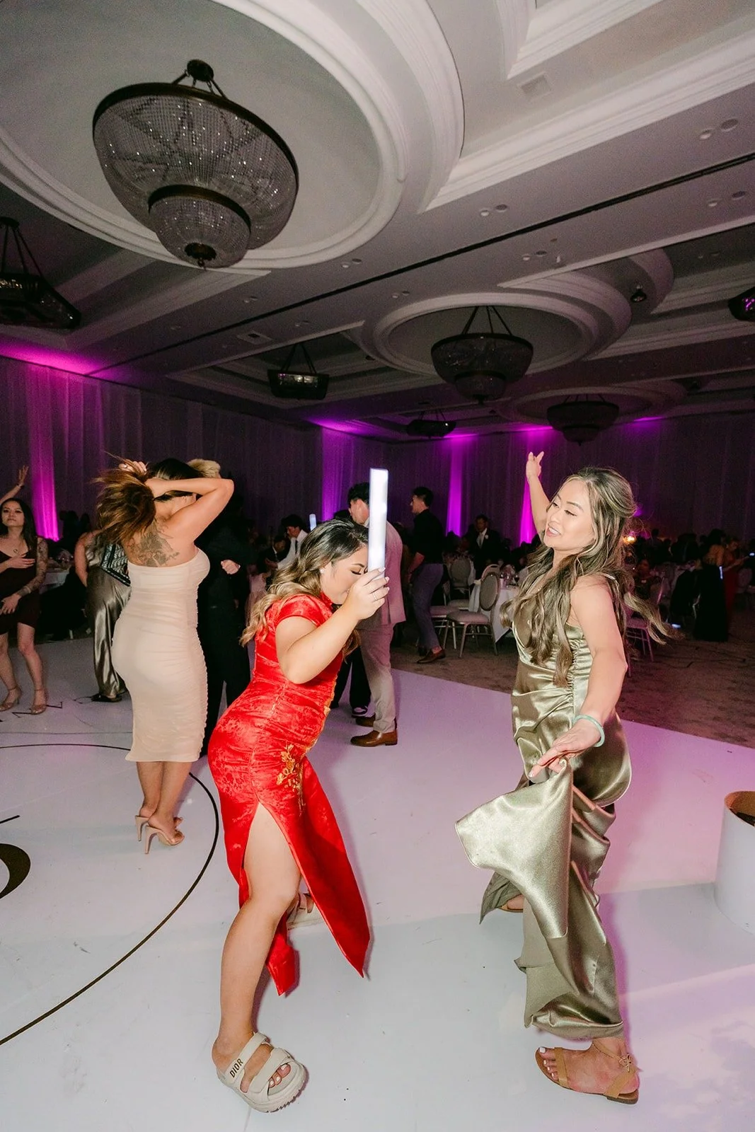 Candice dancing with friends on the monogrammed floor