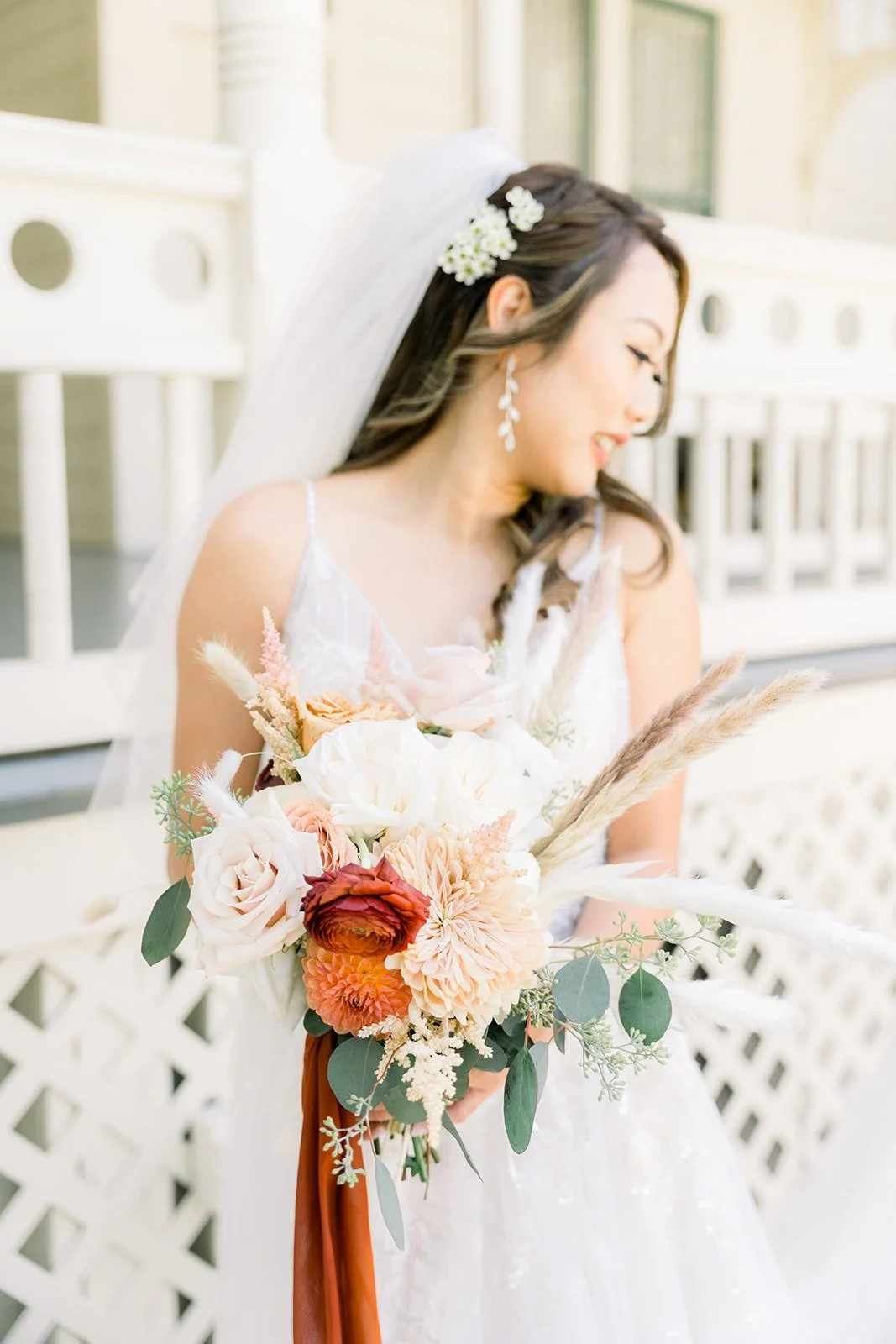 Close portrait of Ariel with her bouquet on the porch