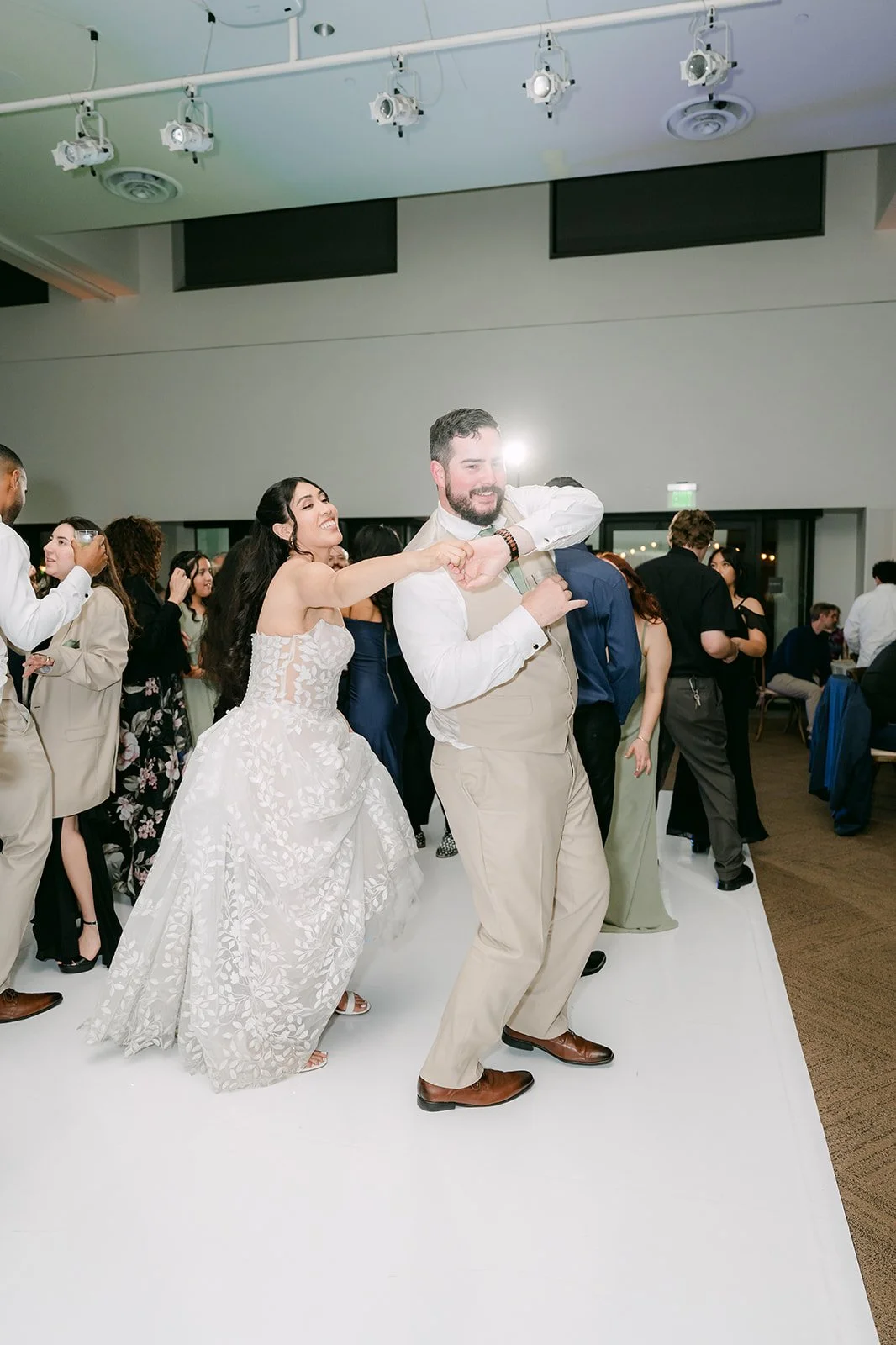 Fernanda and Cody dancing on a packed floor, photographed by One and Only Production.