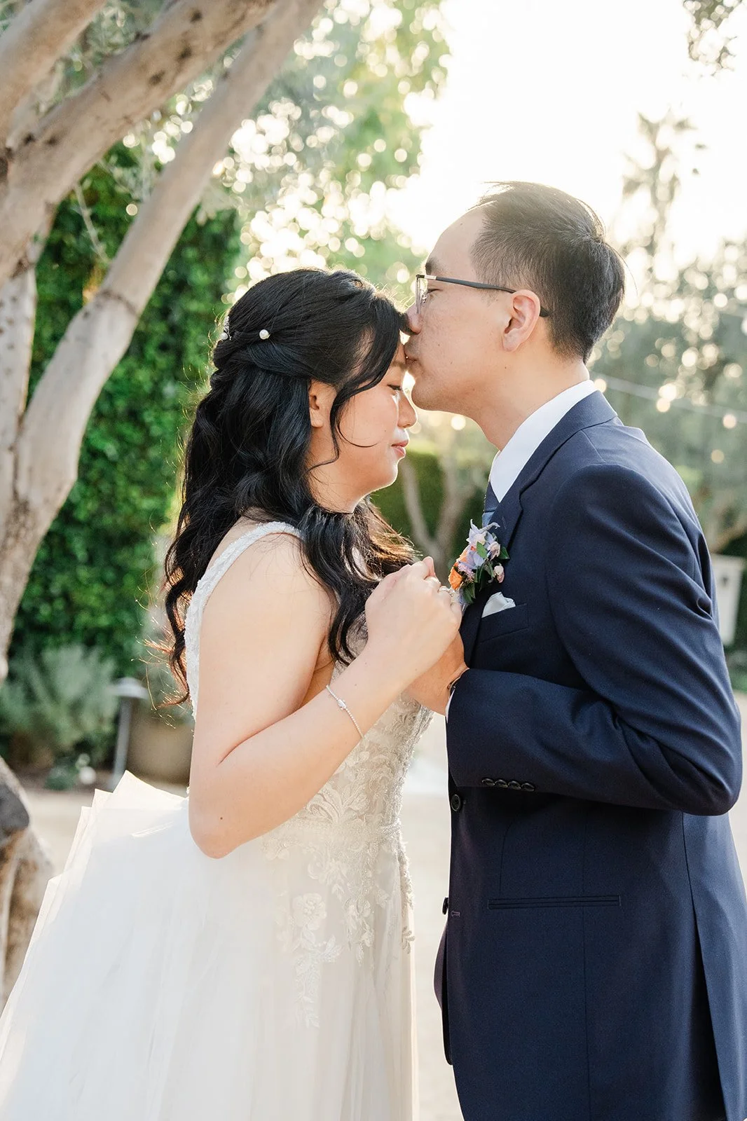 Lawrence kissing Constance's forehead in warm evening light