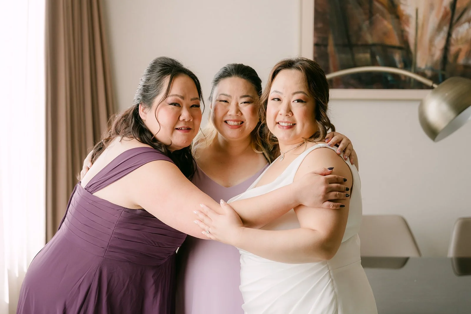 Mai and her bridesmaids in a group hug.