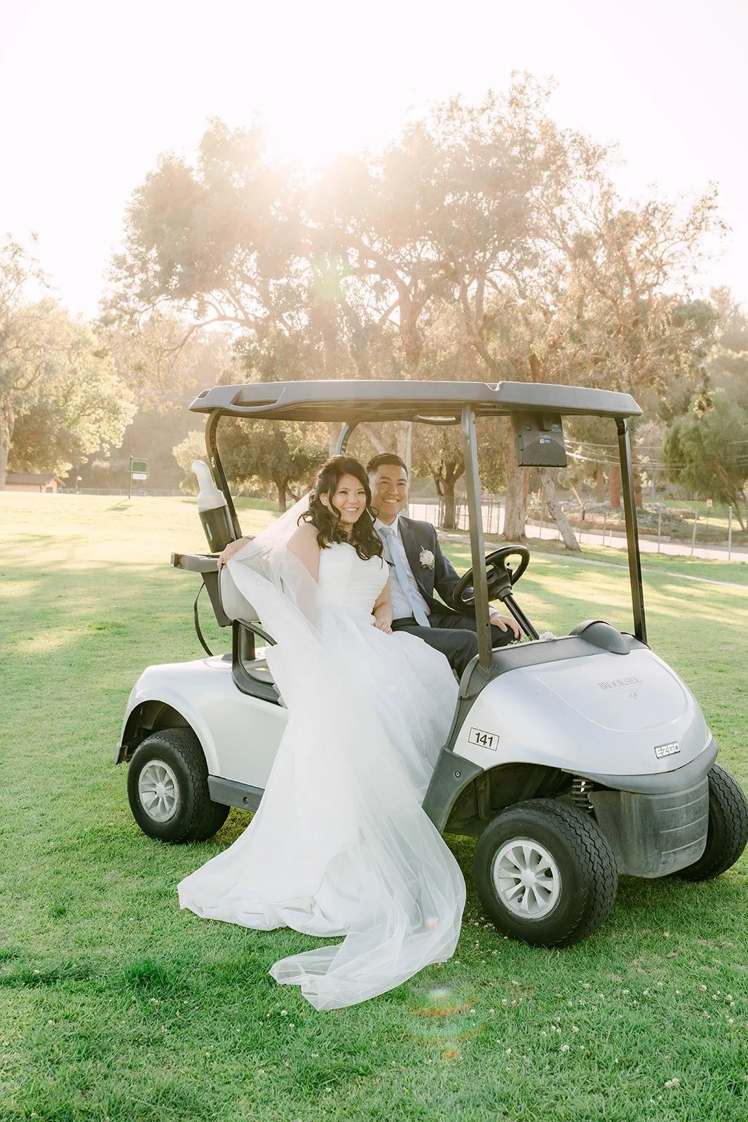 Florence riding in a golf cart across the course, photographed by One and Only Production
