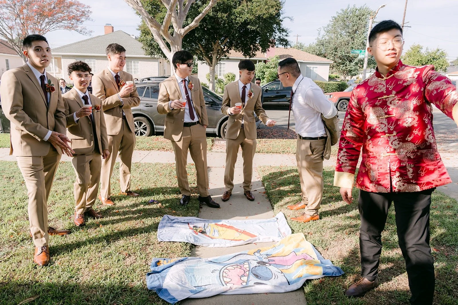 Groomsmen gathered on the lawn for the next door game task