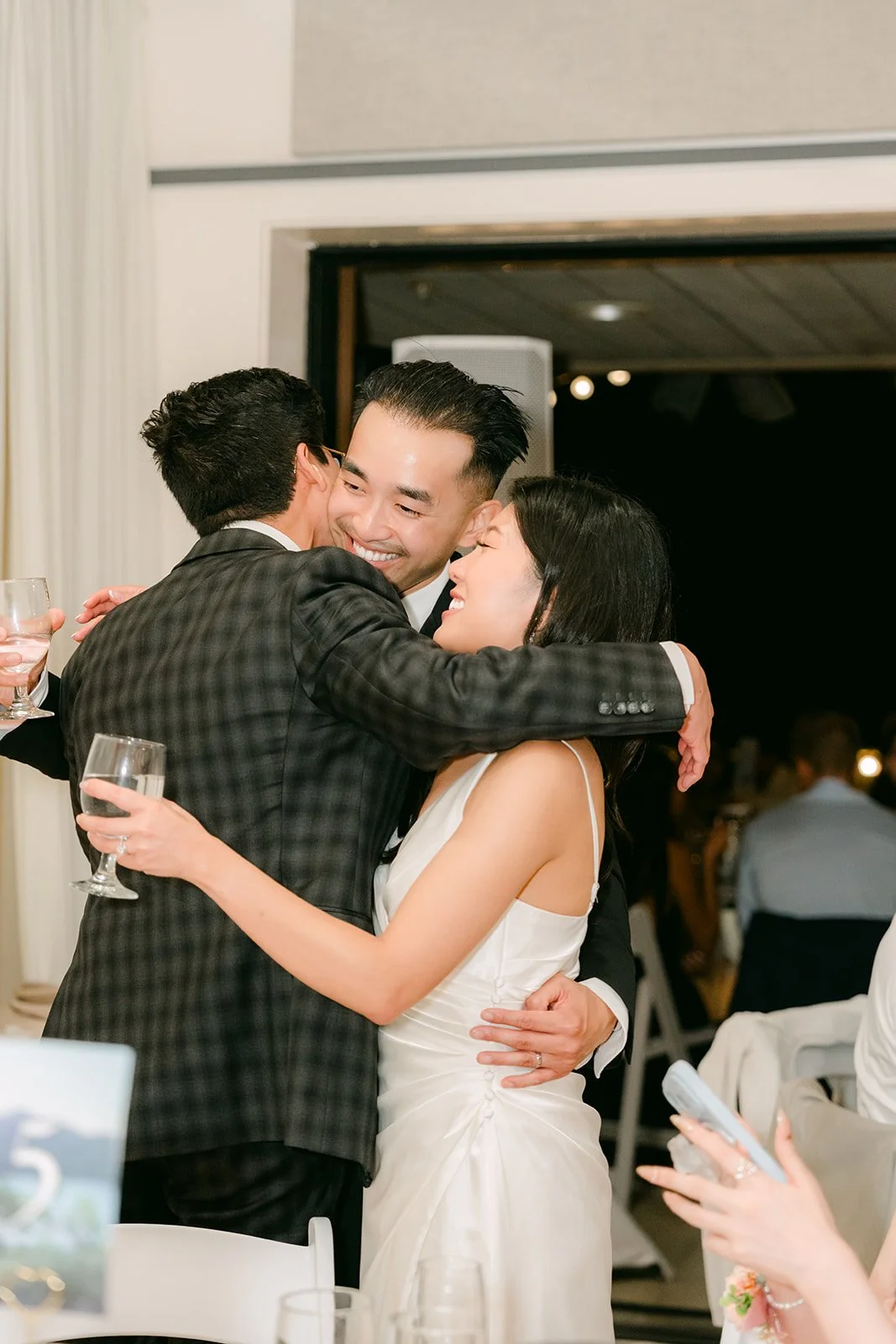 Kim hugging a guest during table greetings