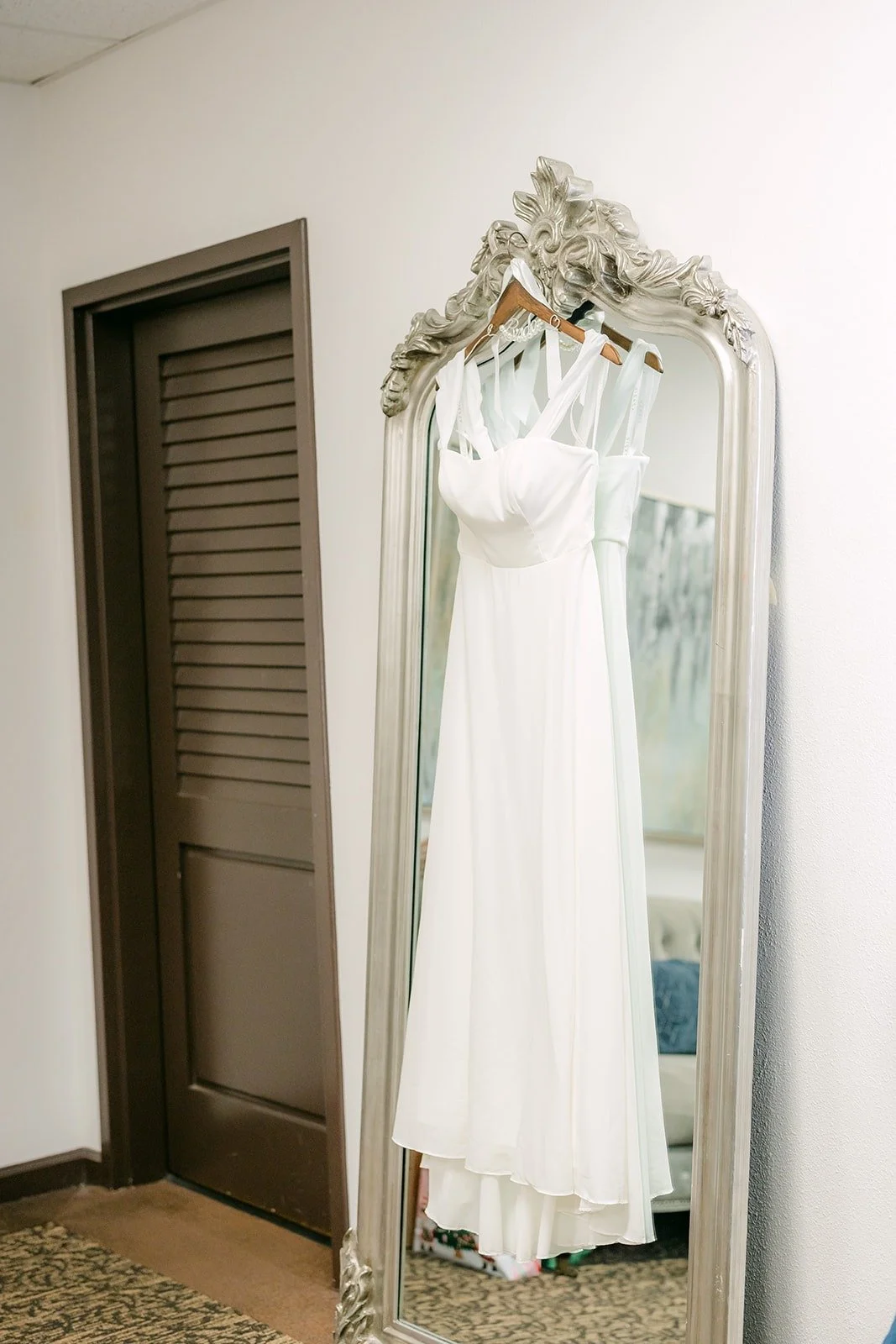 Ivy's gown hanging in the bridal suite at Aliso Viejo by Wedgewood Weddings