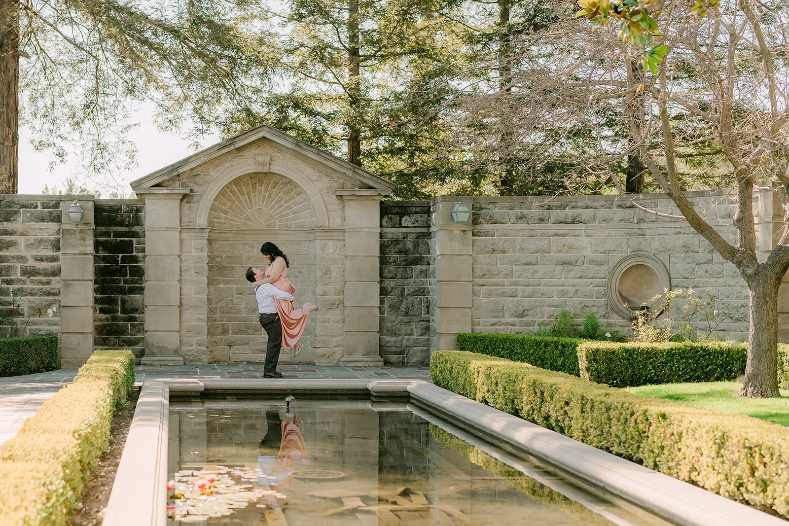 Saira and Matthew framed by the pavilion at the end of the reflecting pool.