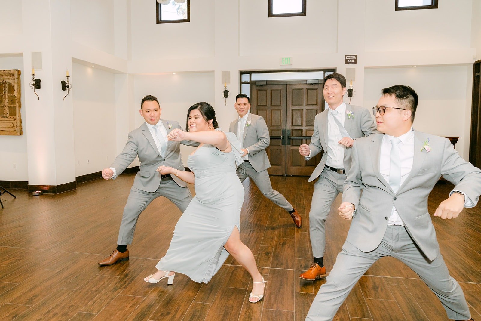 Groomsmen and bridesmaids dancing their way into the parlor