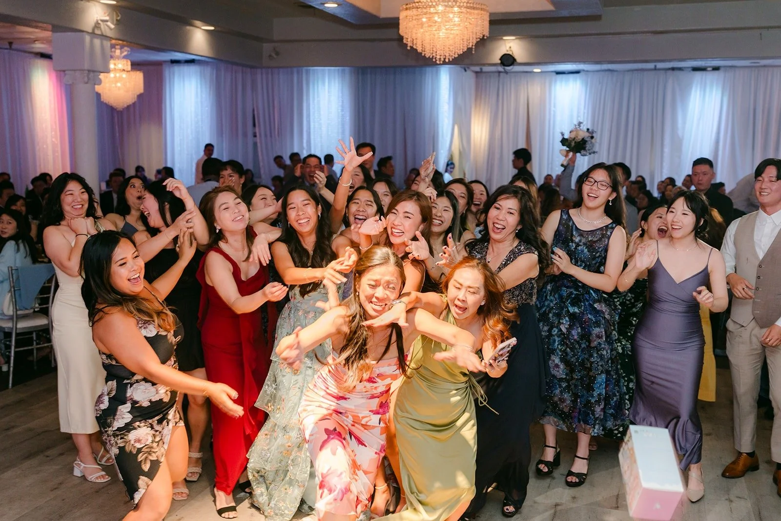 Guests crowding the dance floor for the Labubu toss