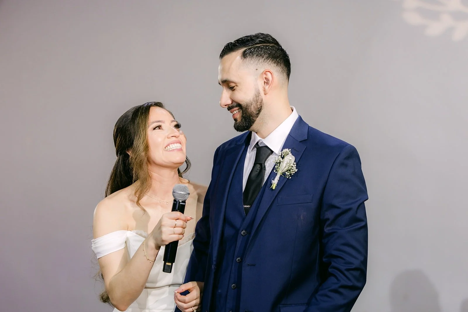 Mariana smiling at Danny as they speak to their guests