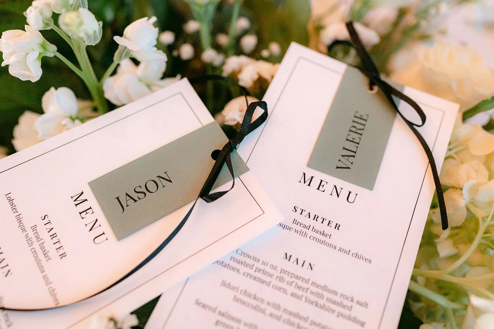 Menu cards tied with sage green name tags for Jason and Valerie