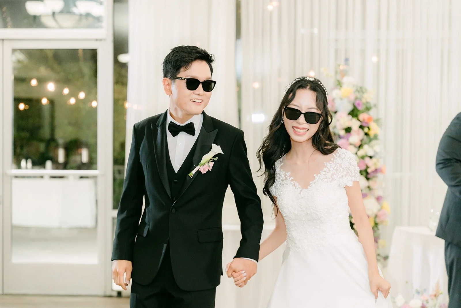 Jeannie and Eunsang walking into the reception hand in hand