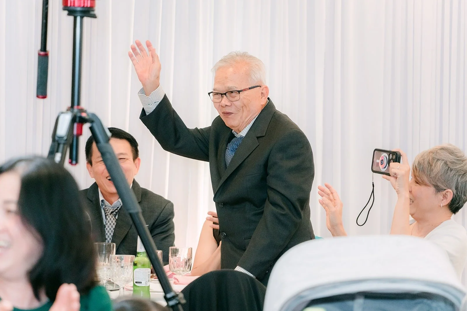 A guest raising his hand in a cheer during the speeches