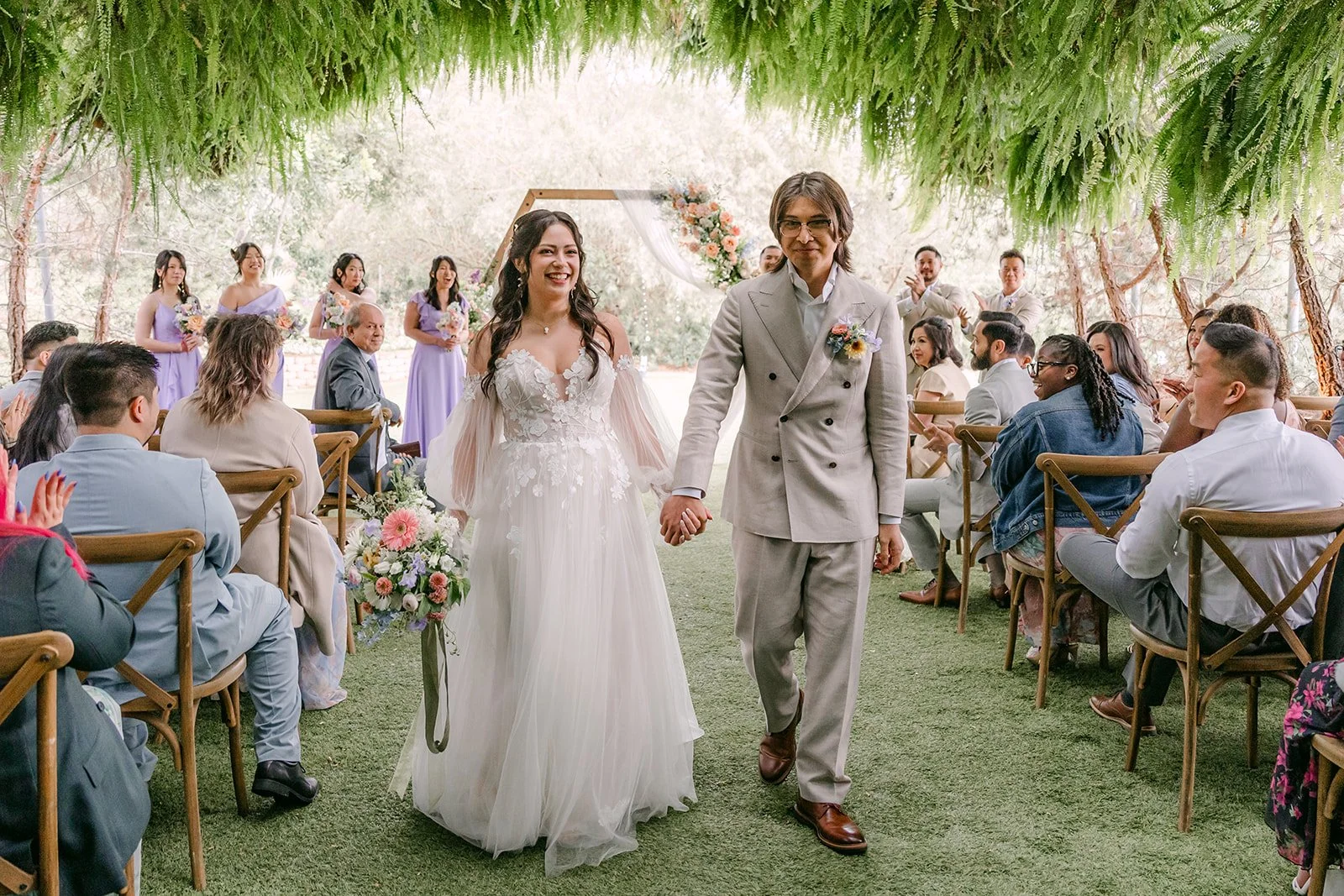 Kat and Mike walking back up the aisle as husband and wife