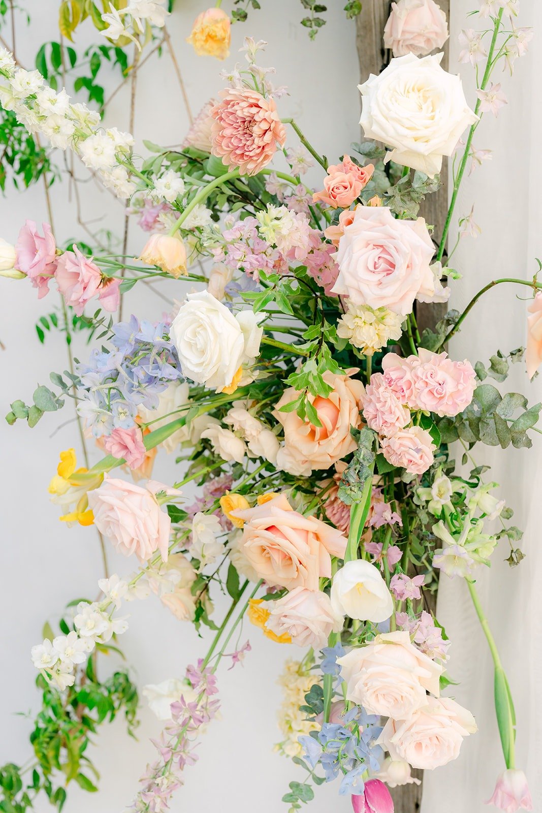 Pastel roses and sweet peas in the floral arrangement