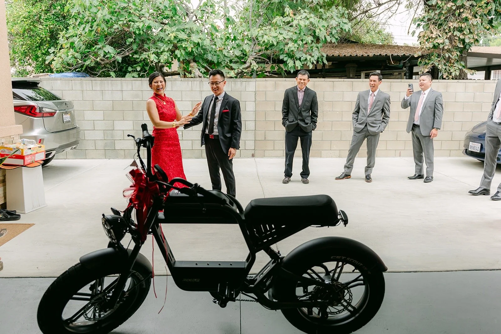 Xuemin and Alex with an electric motorbike in the driveway