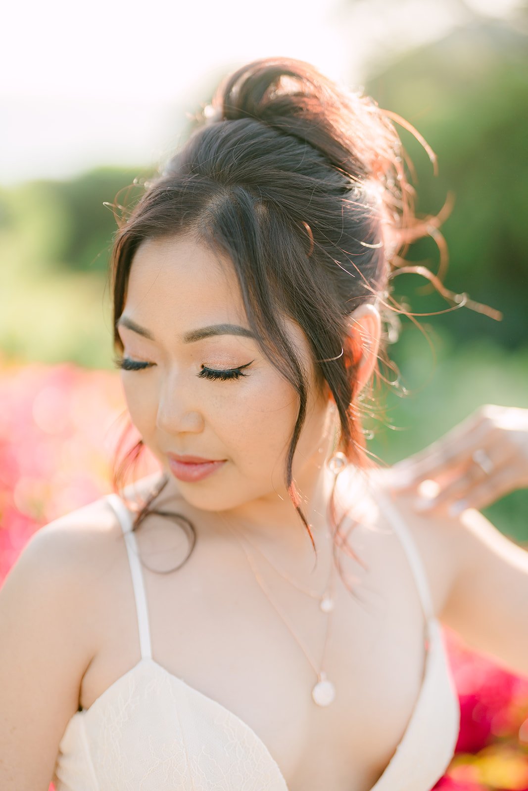 Close-up of Amy in her white dress with her hair pinned up, photographed by One and Only Production.